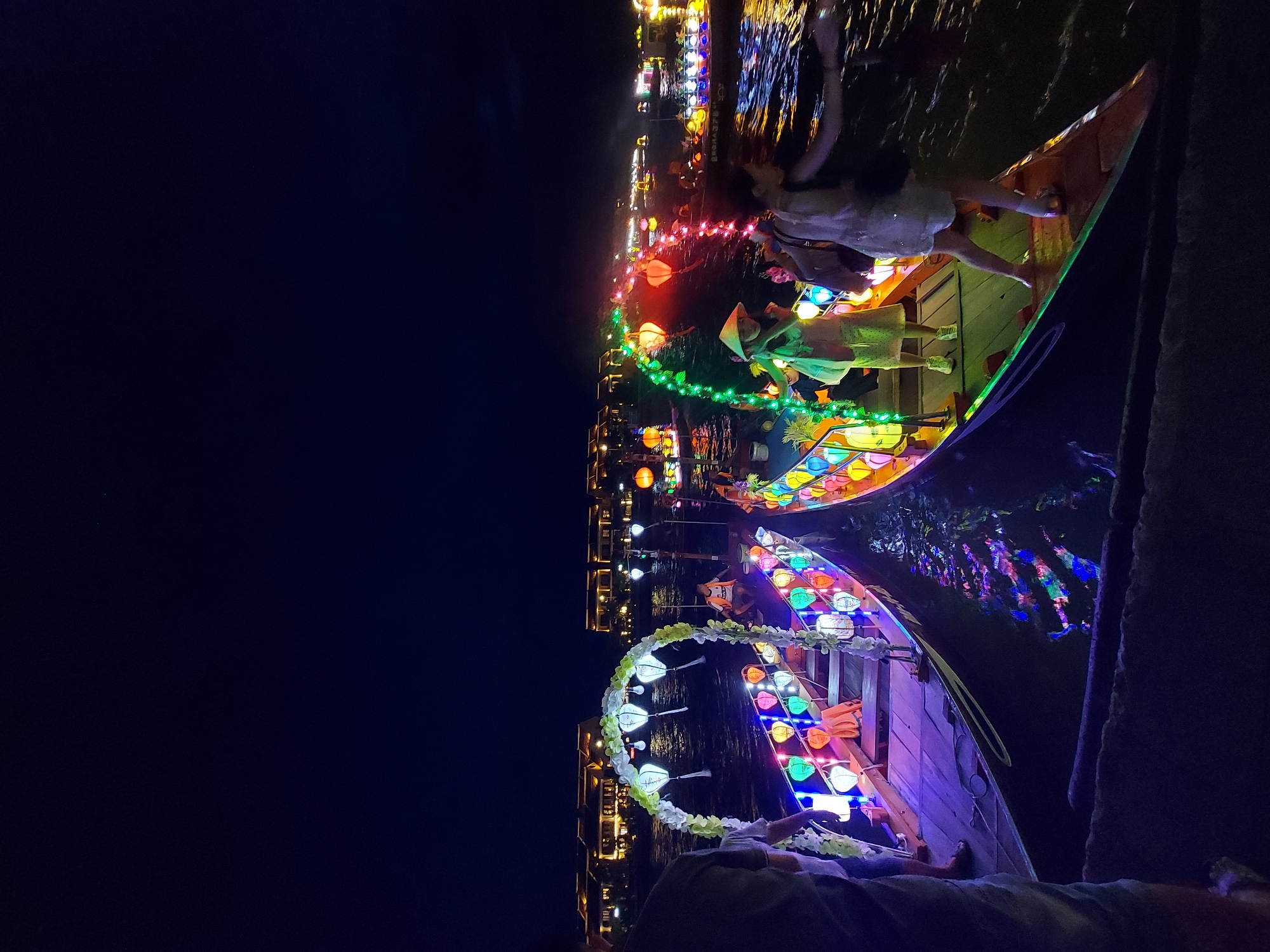 Lantern-covered festival boats glow on Hoi An's Thu Bon River