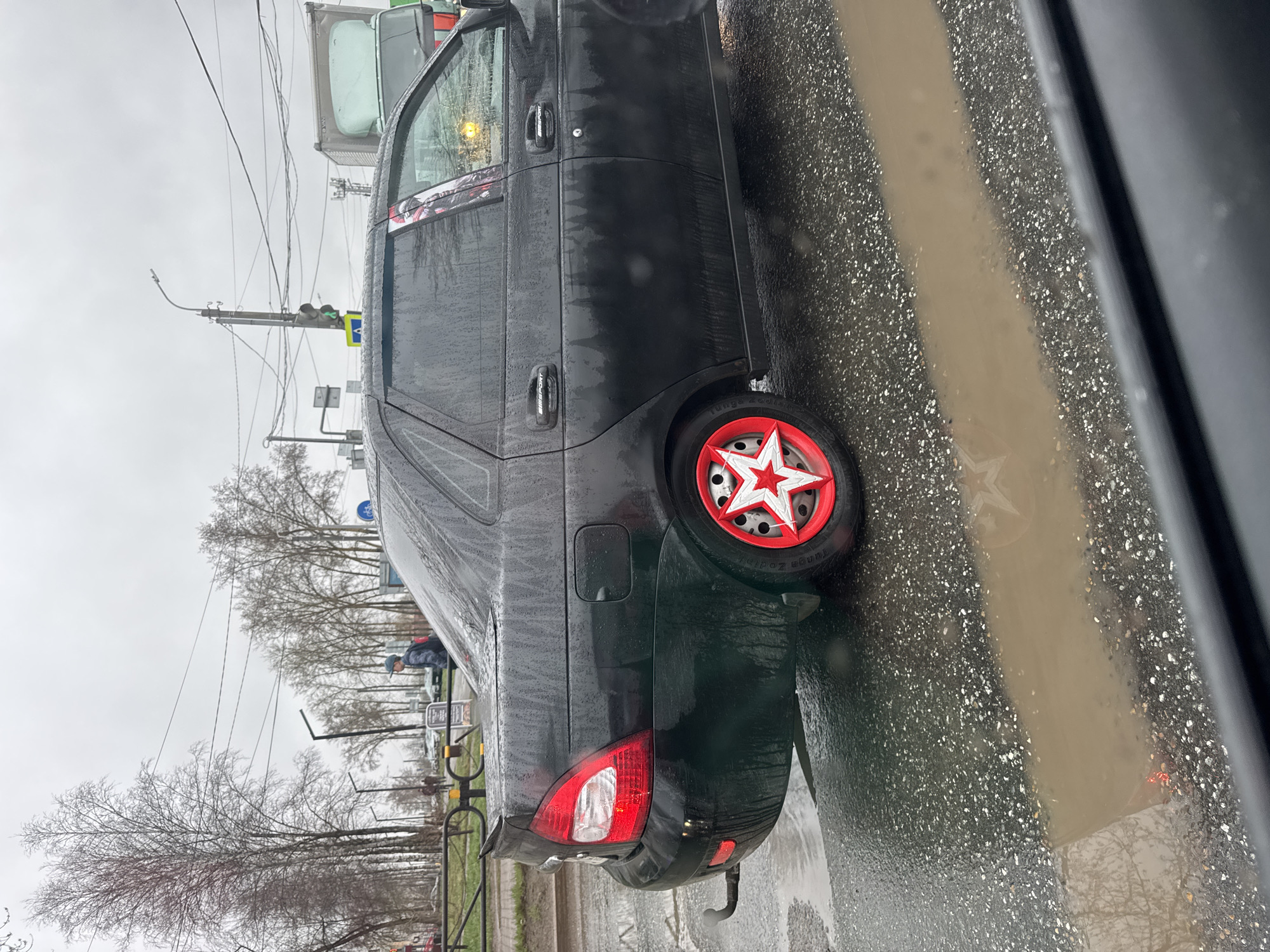Lada with star wheel covers spotted on wet Chaikovsky street