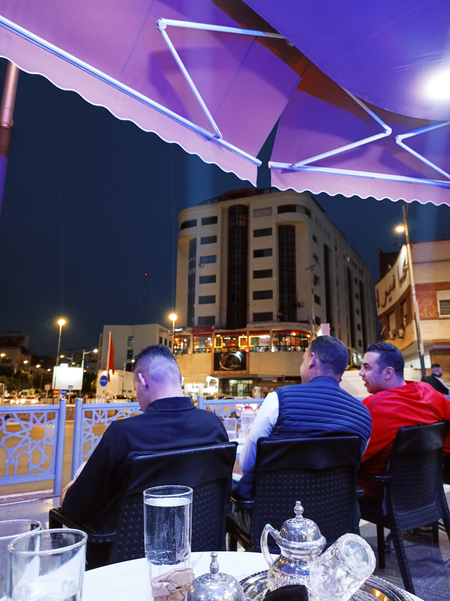 Evening tea gathering at Meknes cafe captured at dusk