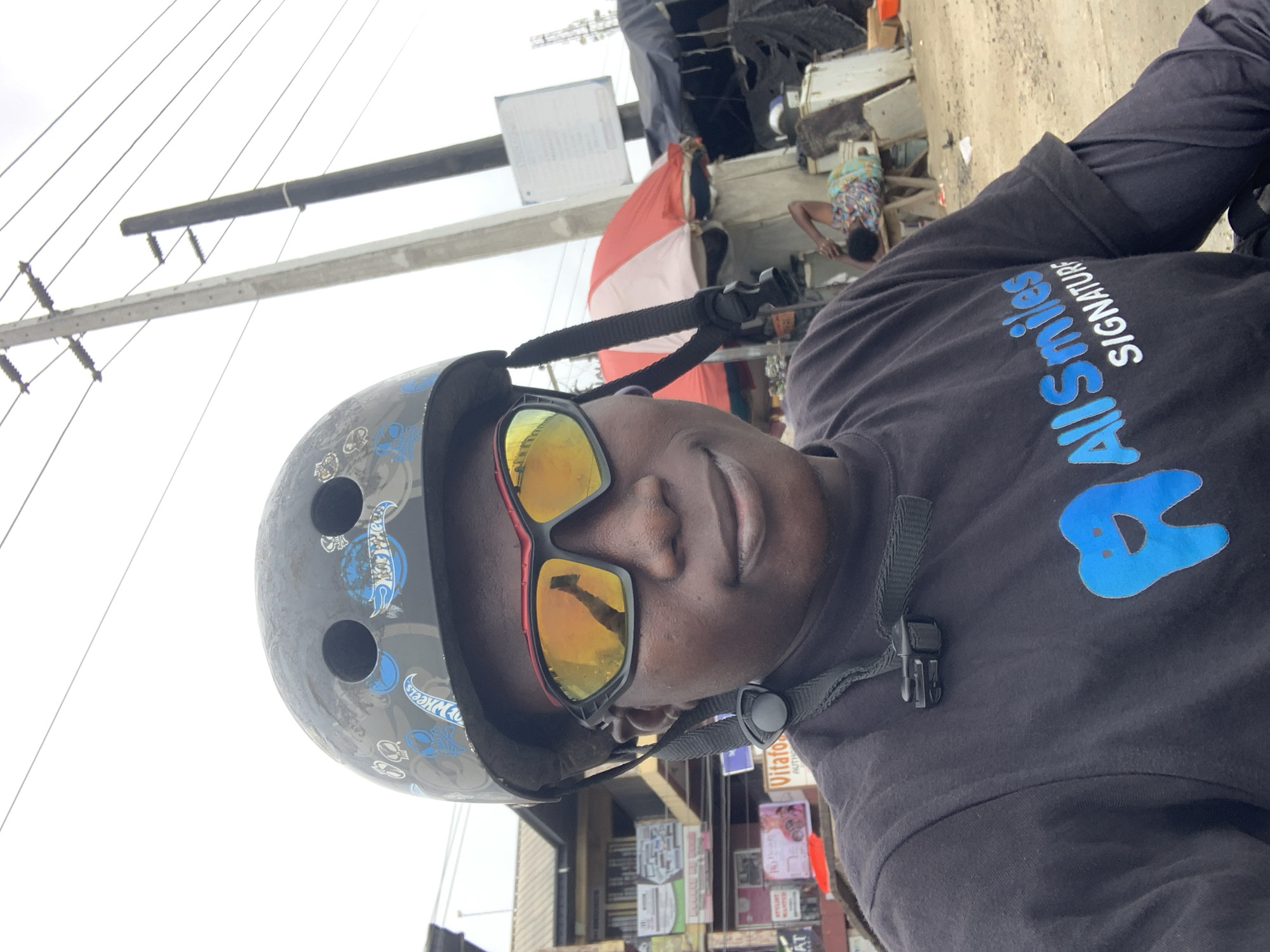 Helmeted selfie series on a Lagos street, AllSmiles SIGNATURE gear