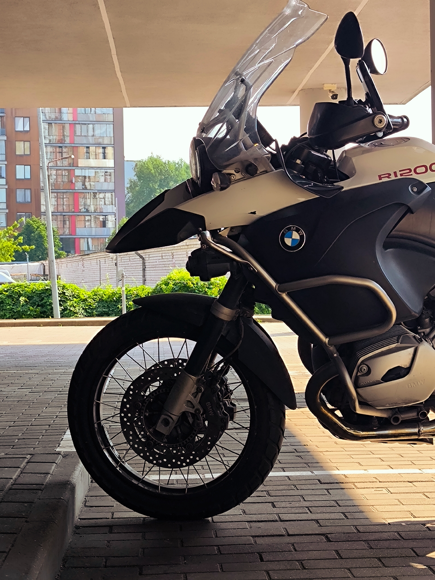 Two BMWs parked outside a Riga building complex