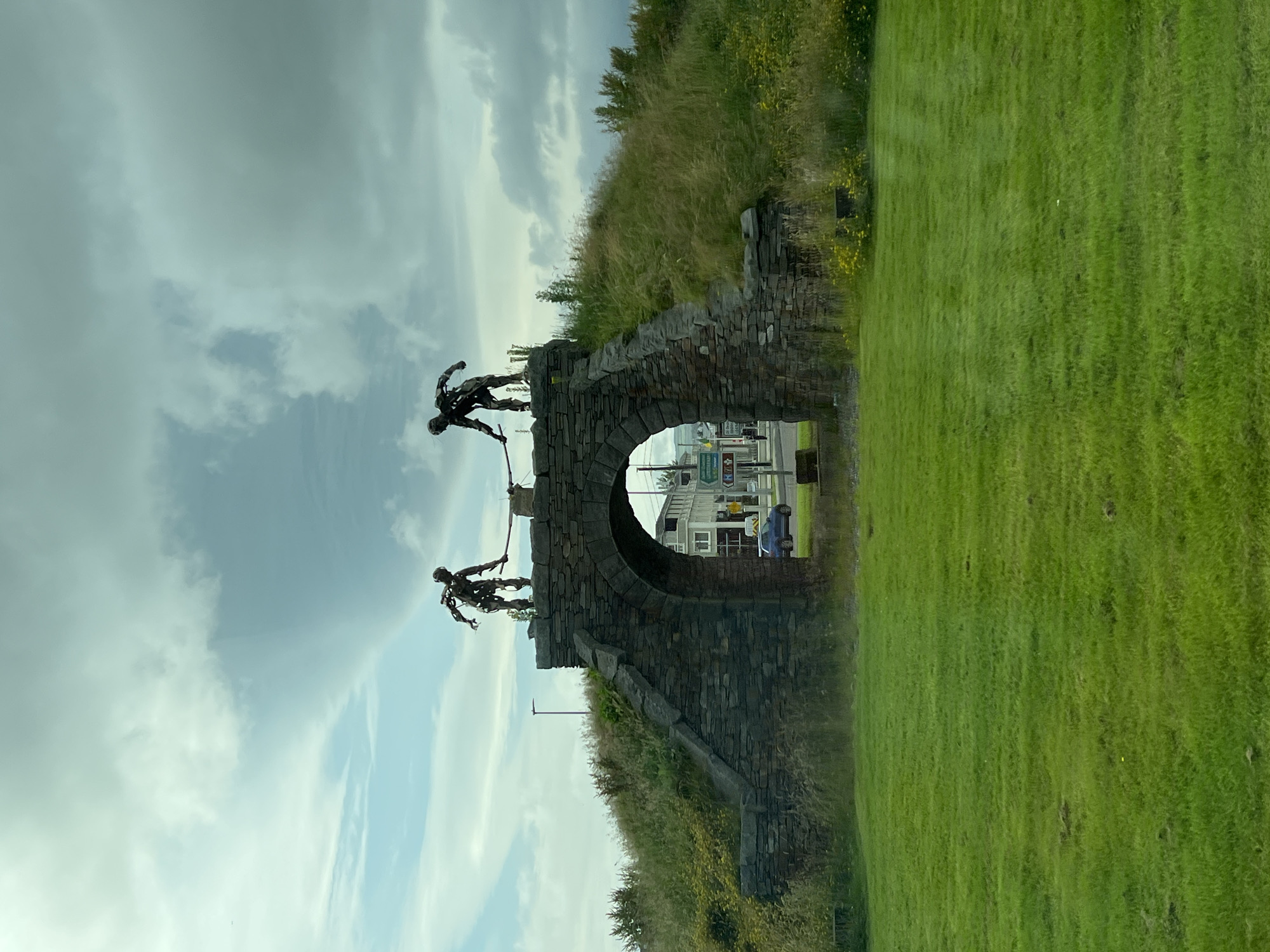 Metal sculptures crown a stone archway in Letterkenny town center