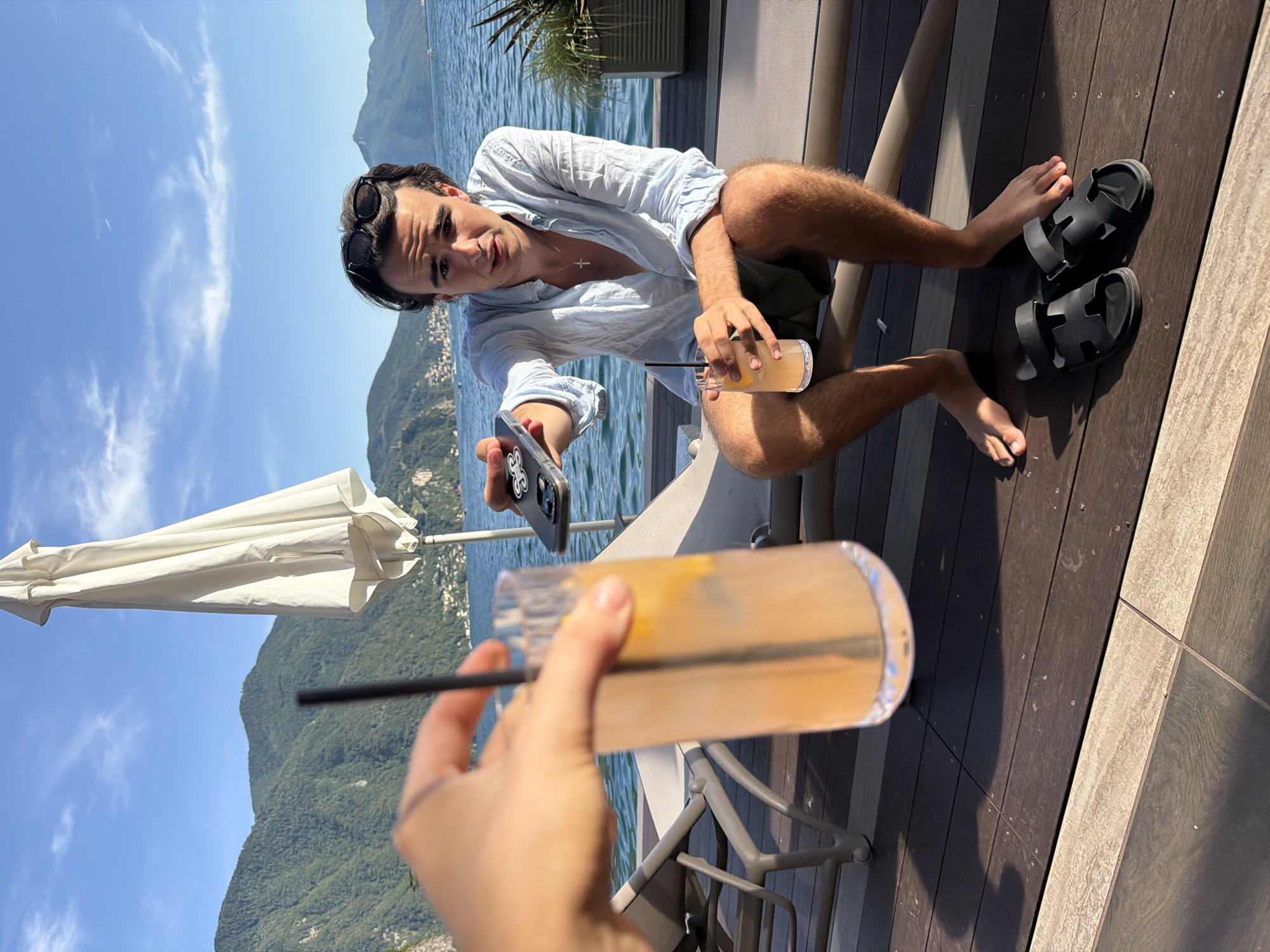 Chilling on a lakeside deck in Lugano, Alps in view