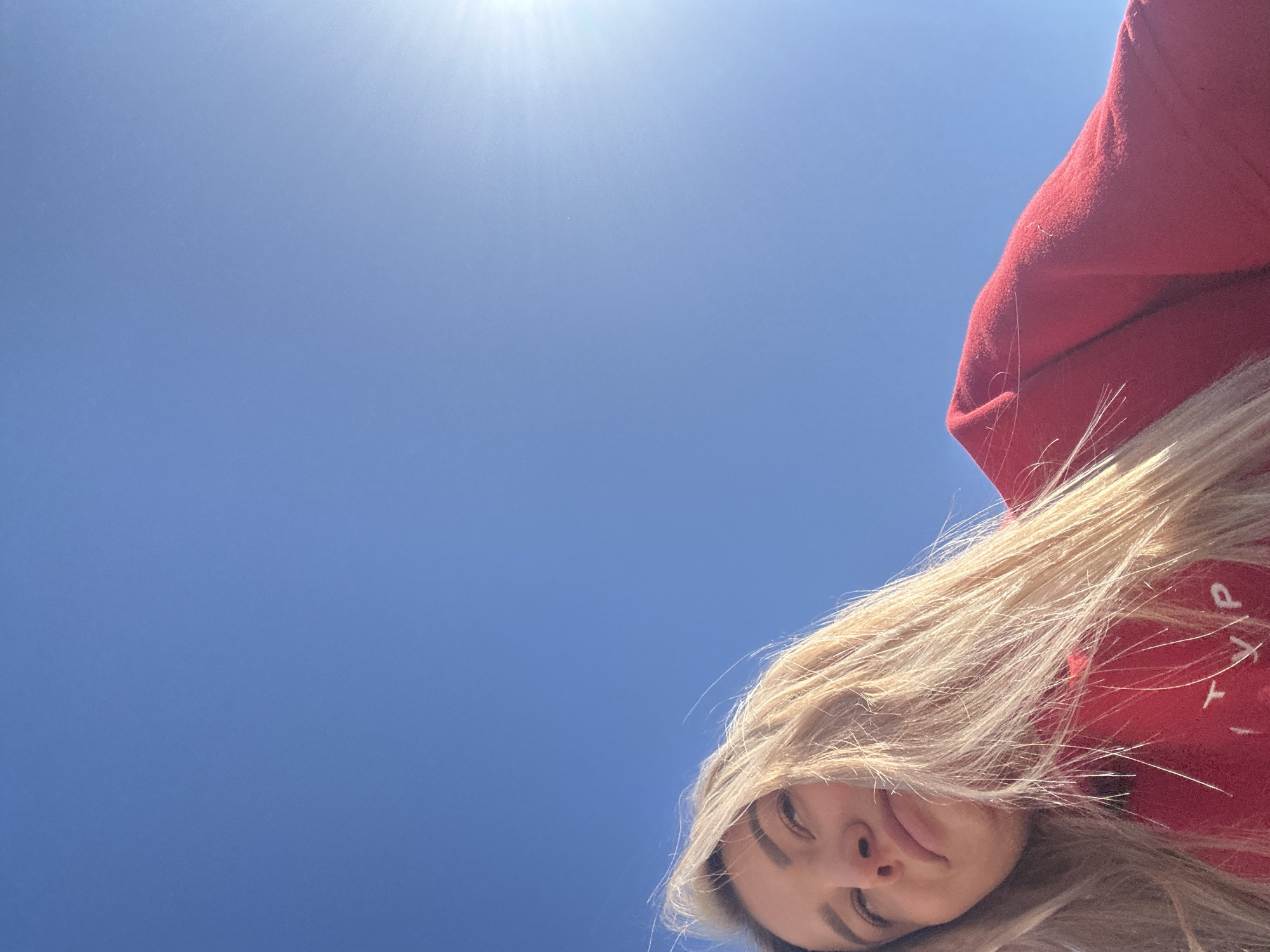 Woman in red sweatshirt walks through Budva streets