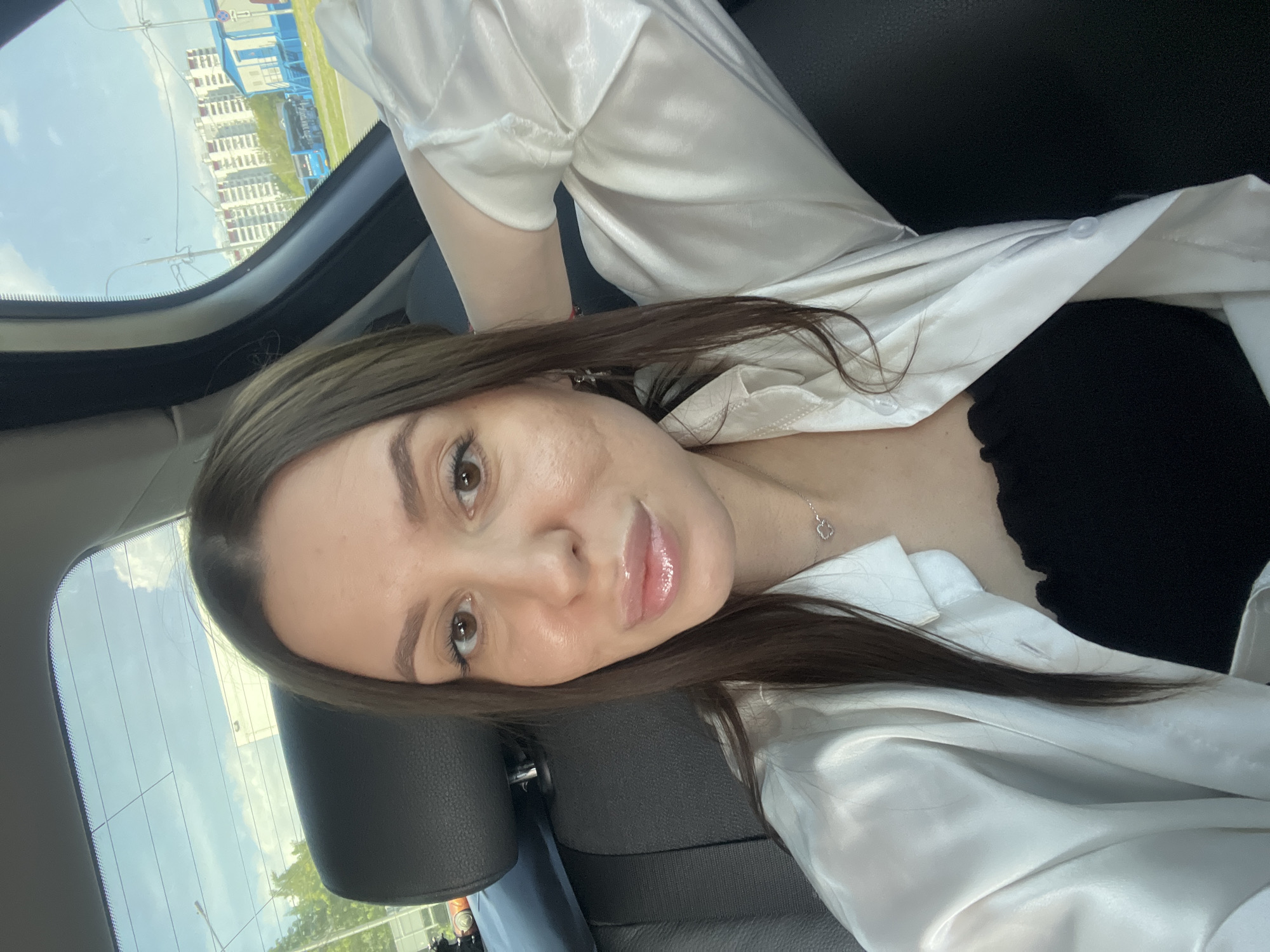 Woman takes selfies in car backseat in Moscow
