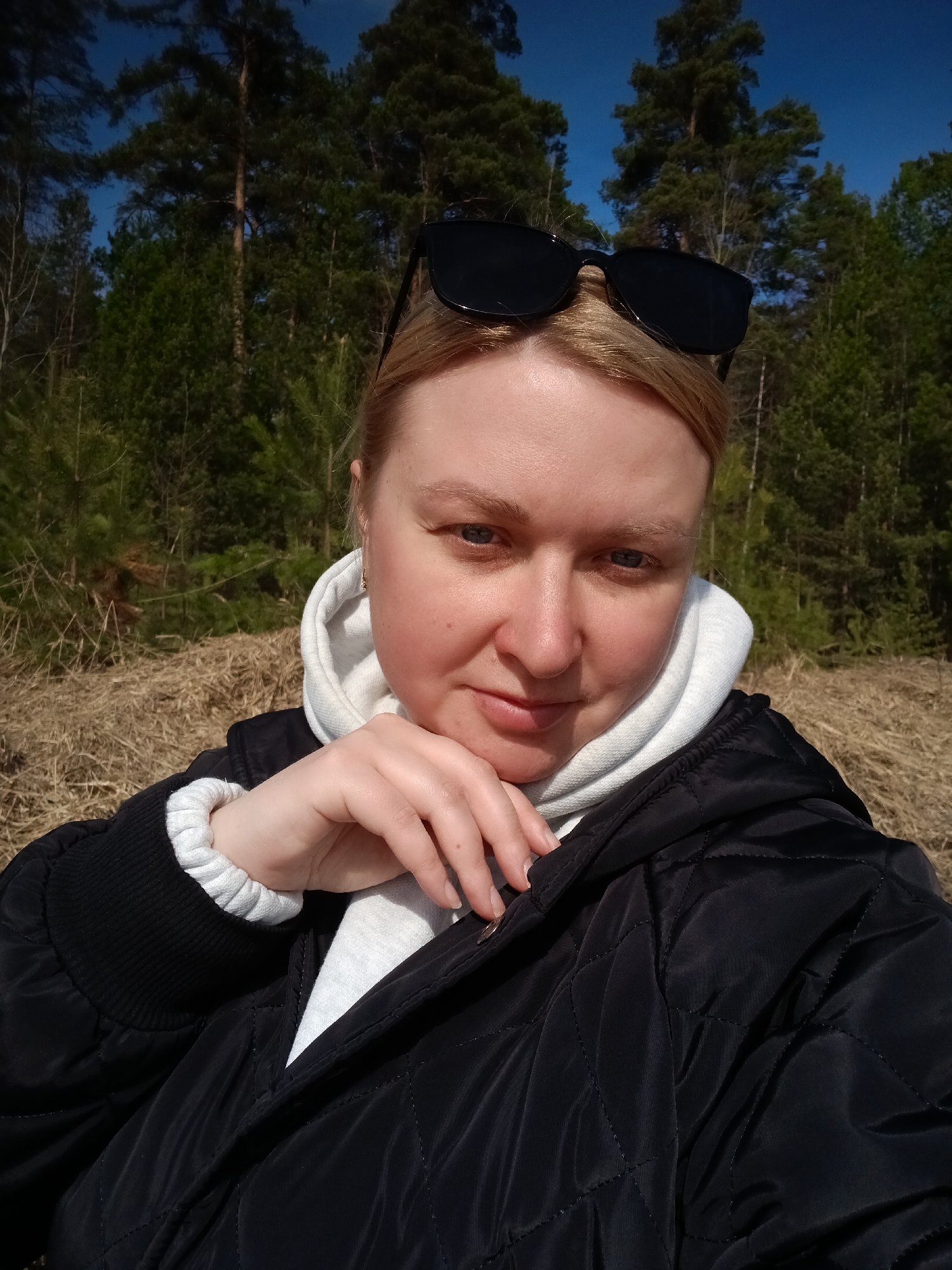Woman takes selfies in spring forest near Dubovaya, Russia
