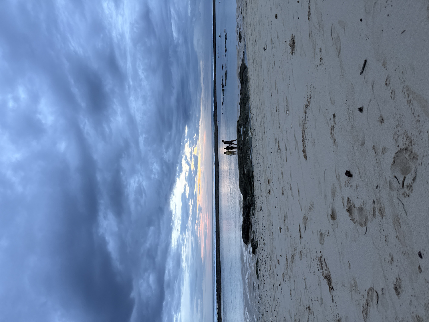 Beach visitor enjoys quiet morning under dramatic skies
