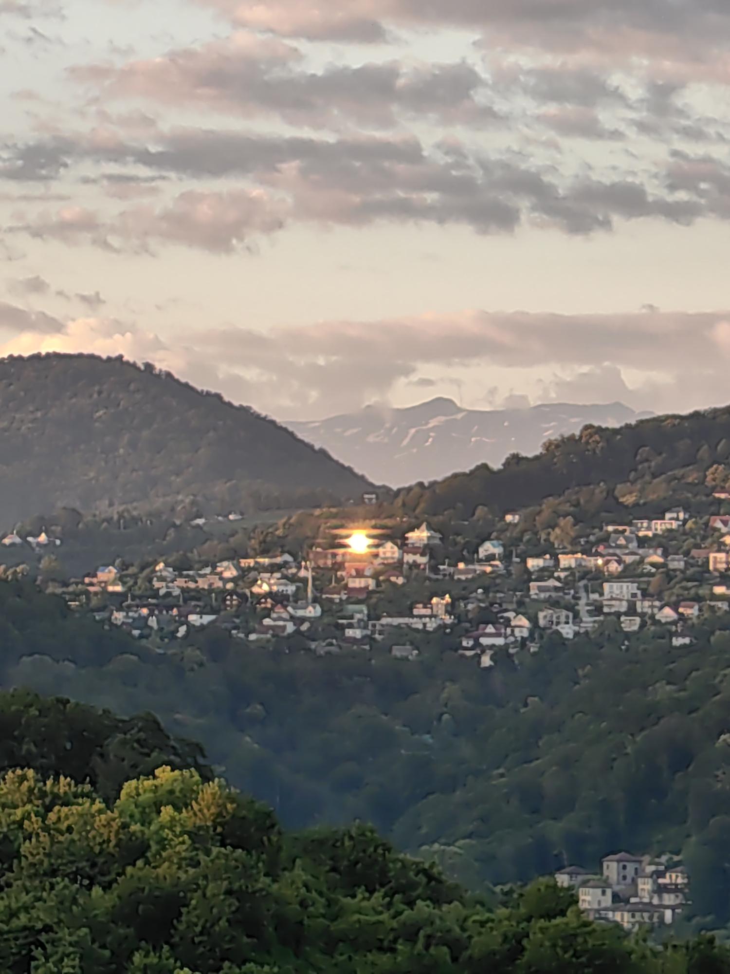 Sochi hillside neighborhood at golden hour, July 2026