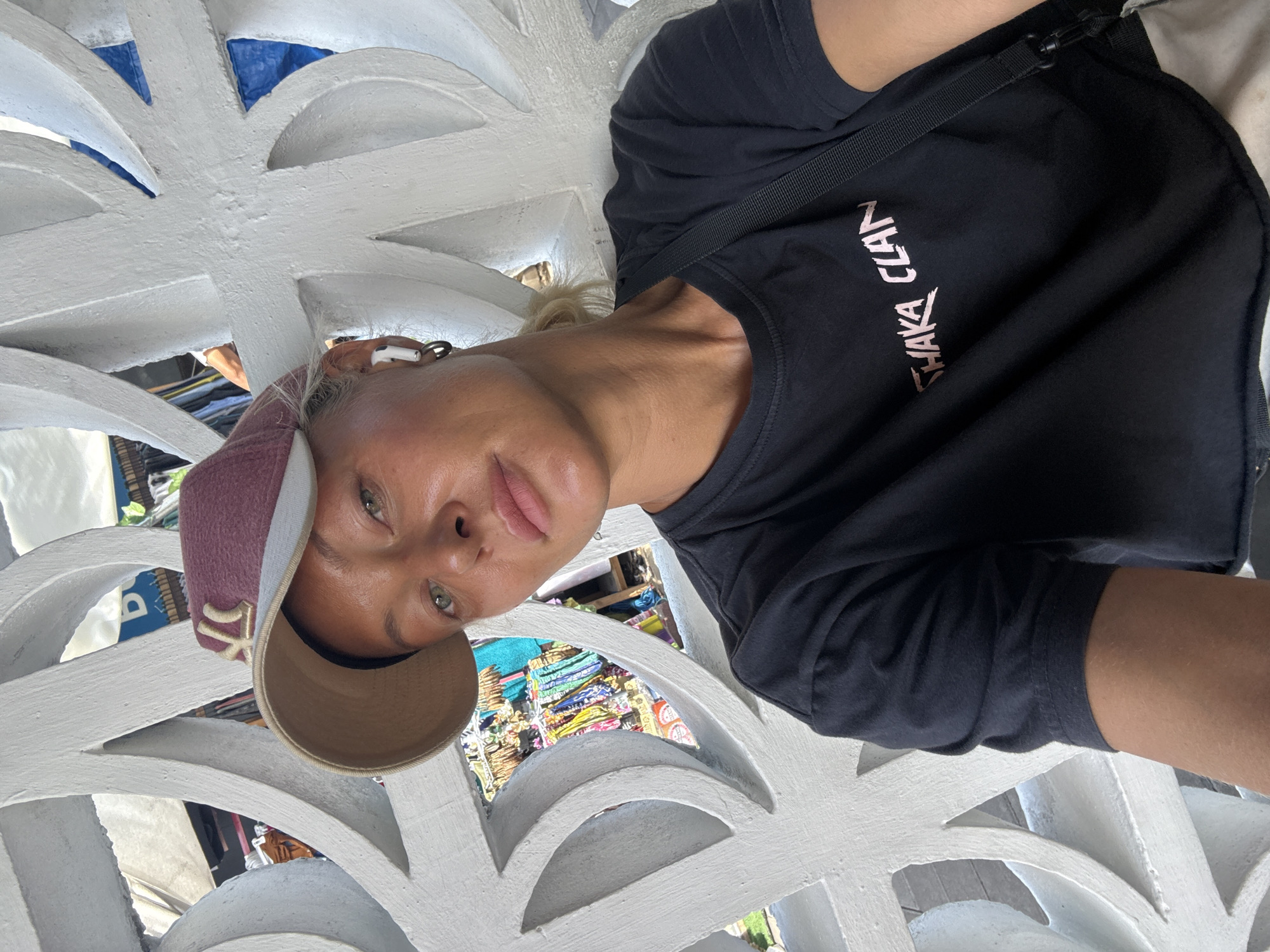 Selfie in a Shaka Clan tee with wireless earbuds