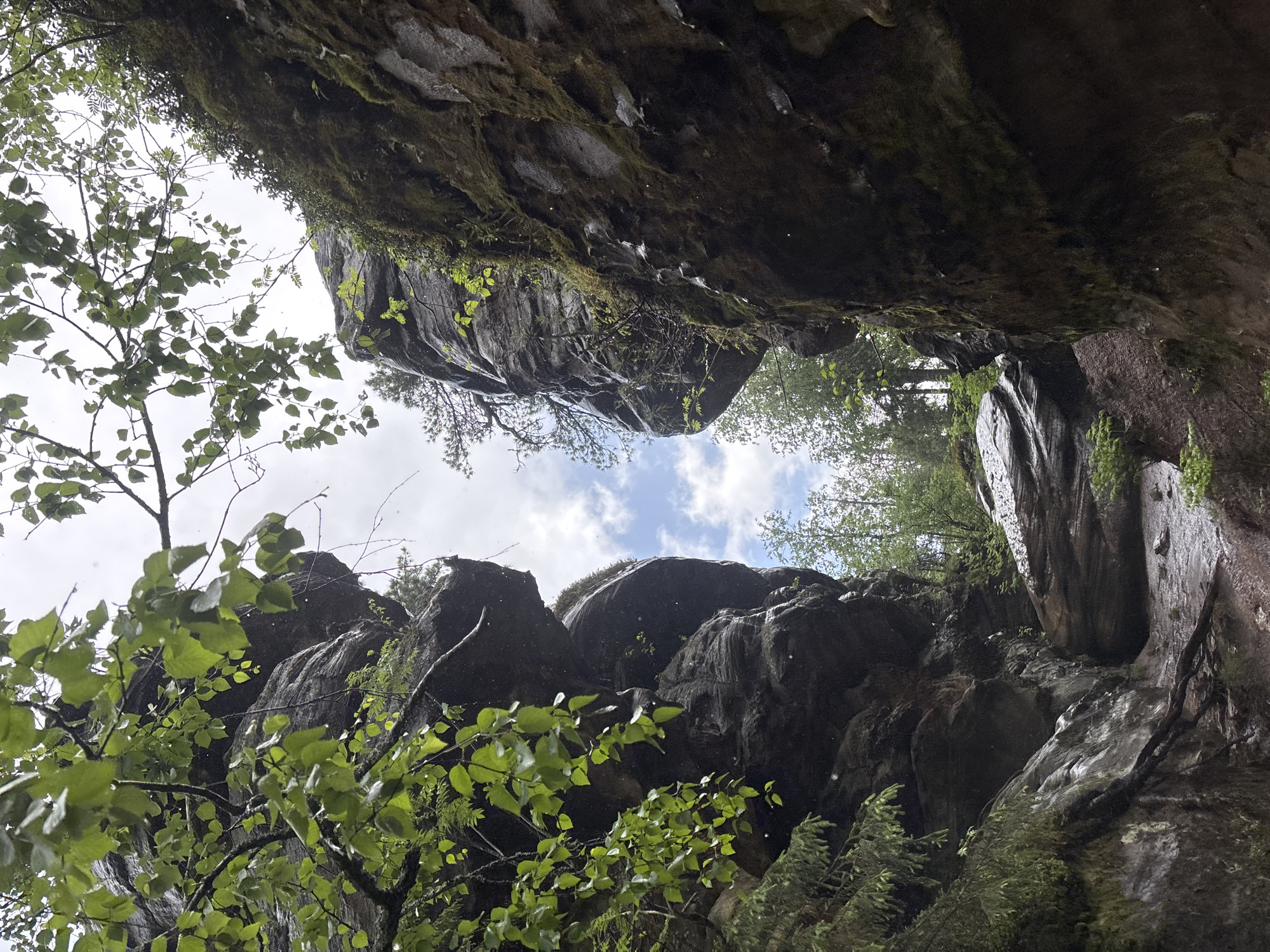 Hikers explore rocky gorge in rainy Shumikhinskii, Russia