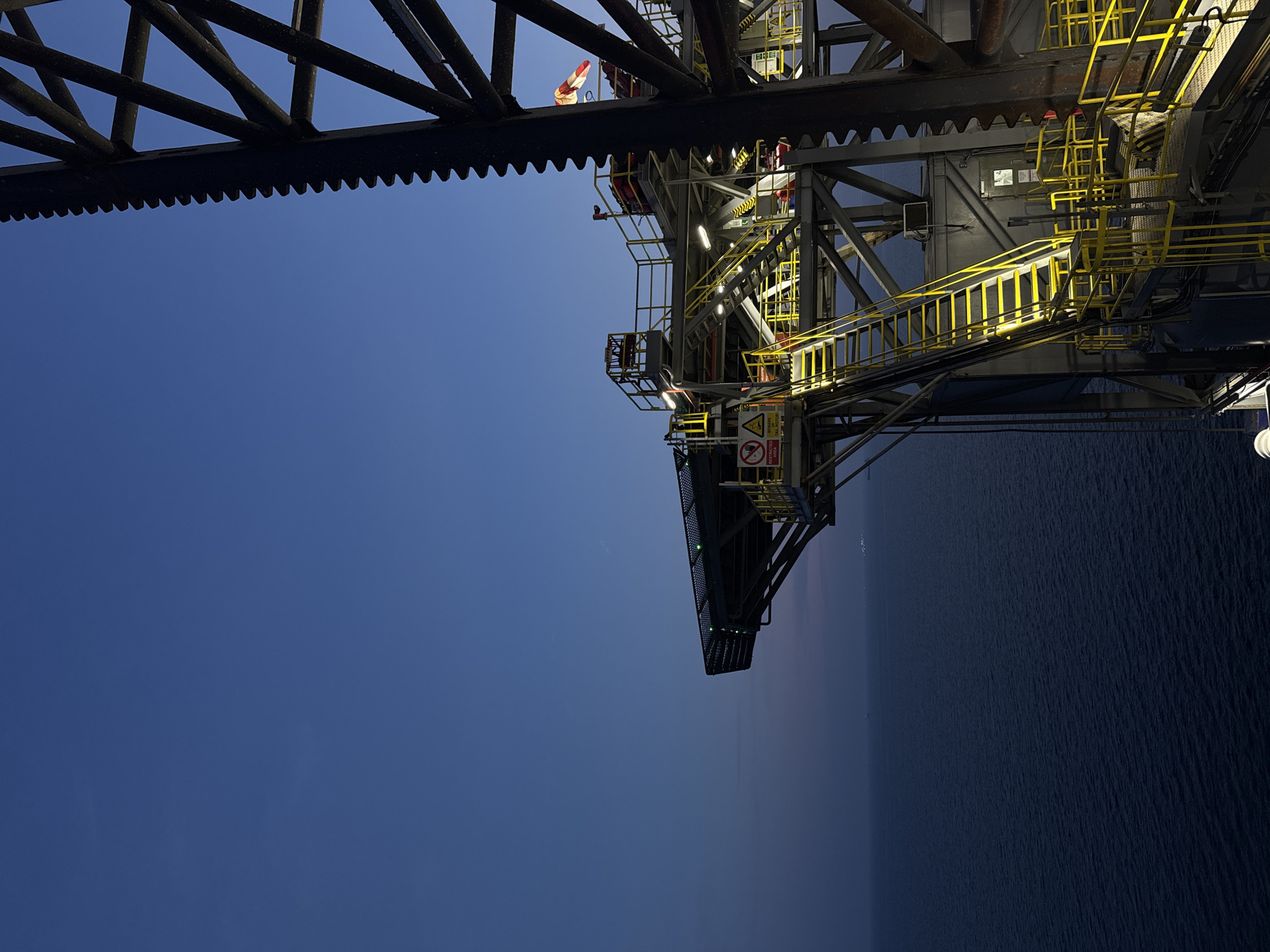 Offshore oil rig at sea, day and golden hour views