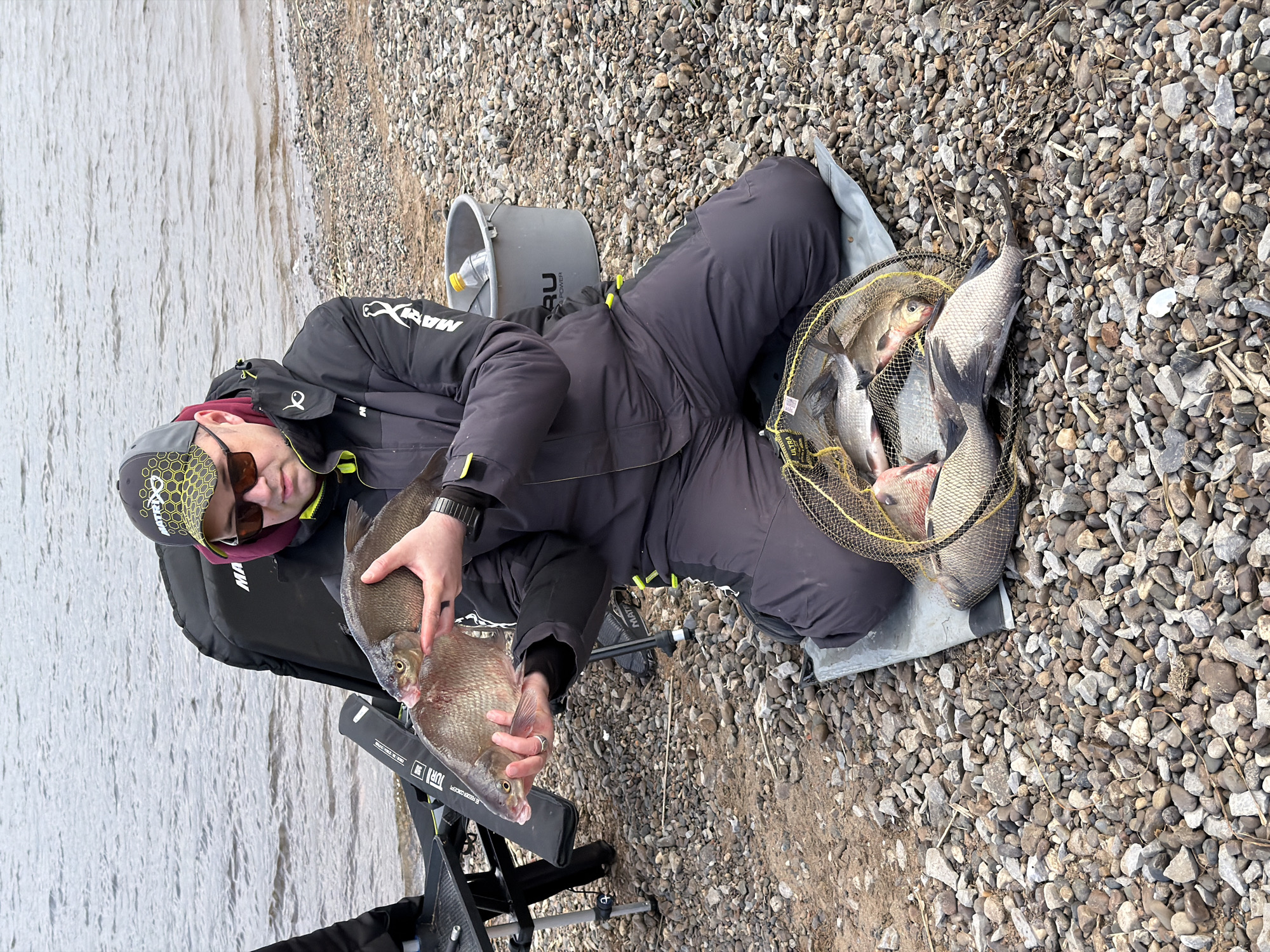 Angler fishes from rocky shore in Chaykovsky, Russia