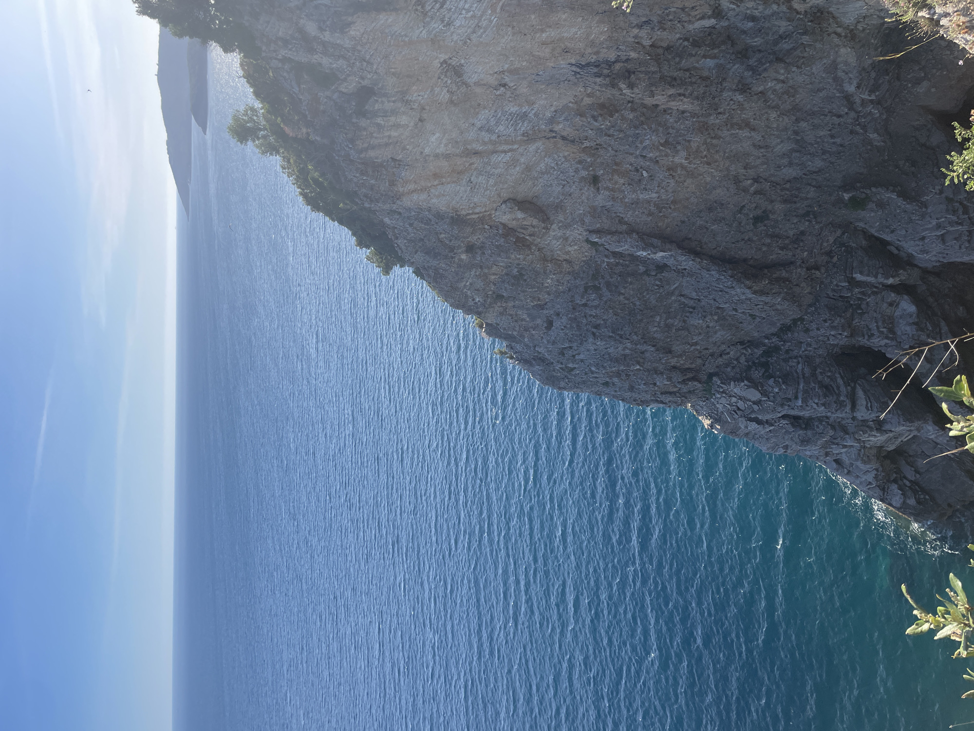 Tourist documents scenic Adriatic cliffs and coastline in Budva