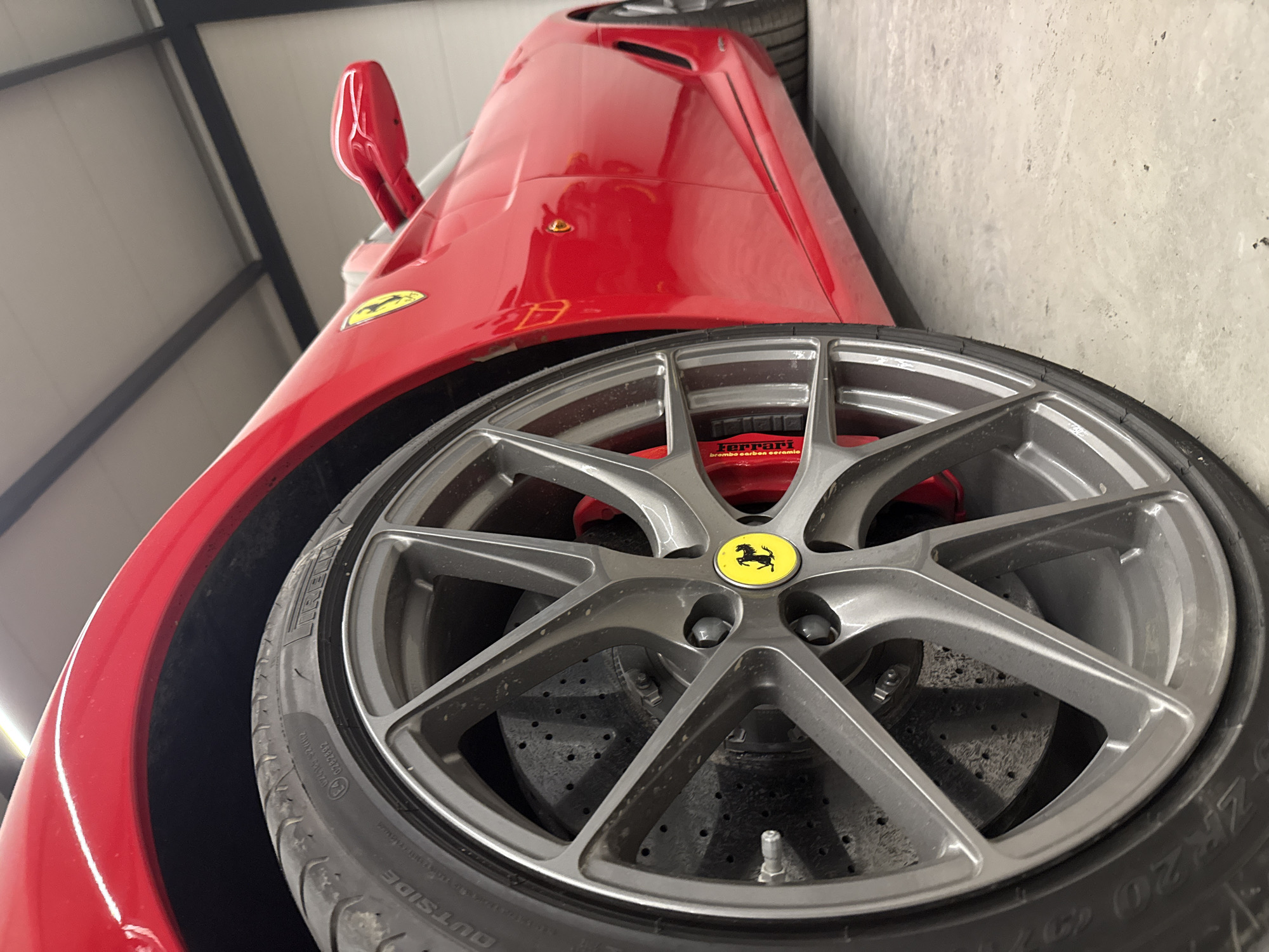Red Ferrari sports car photographed in close-up detail