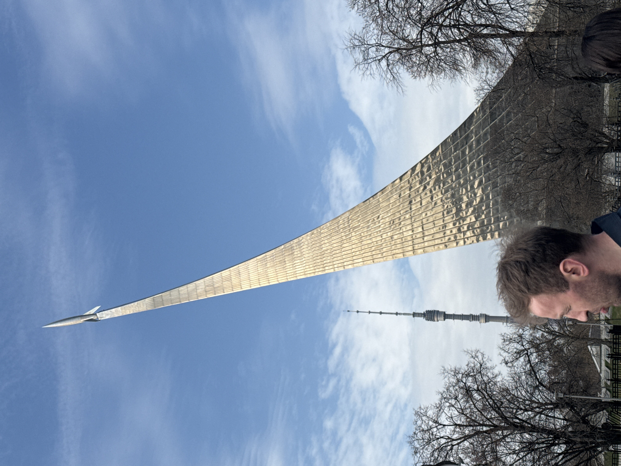 Person smoking near Moscow's Space Monument during morning hours