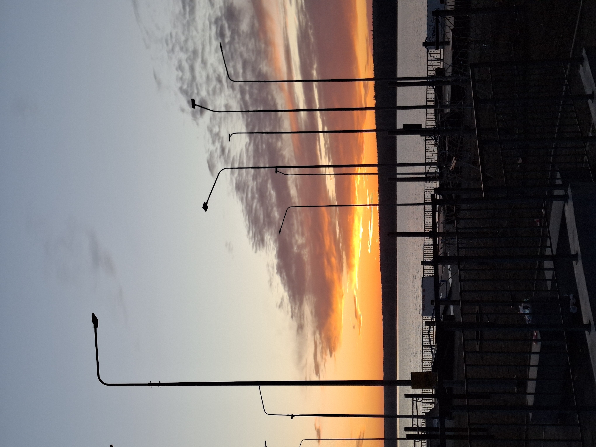 Sunset captured along Chaikovsky waterfront with decorated mermaid statue