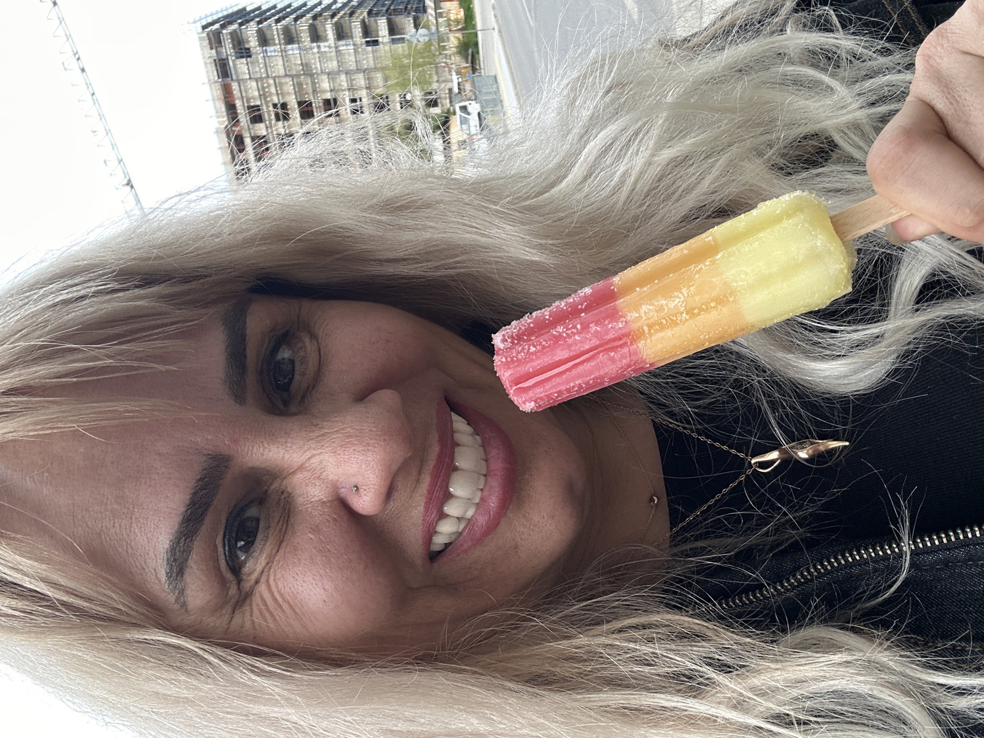 Woman takes cheerful popsicle selfies in Sofia