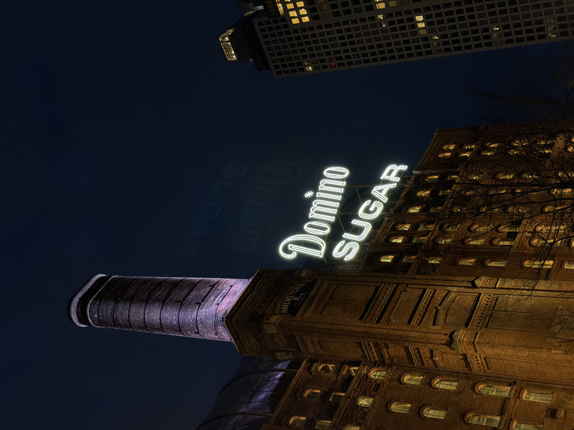 Domino Sugar Refinery building illuminated at night in Brooklyn