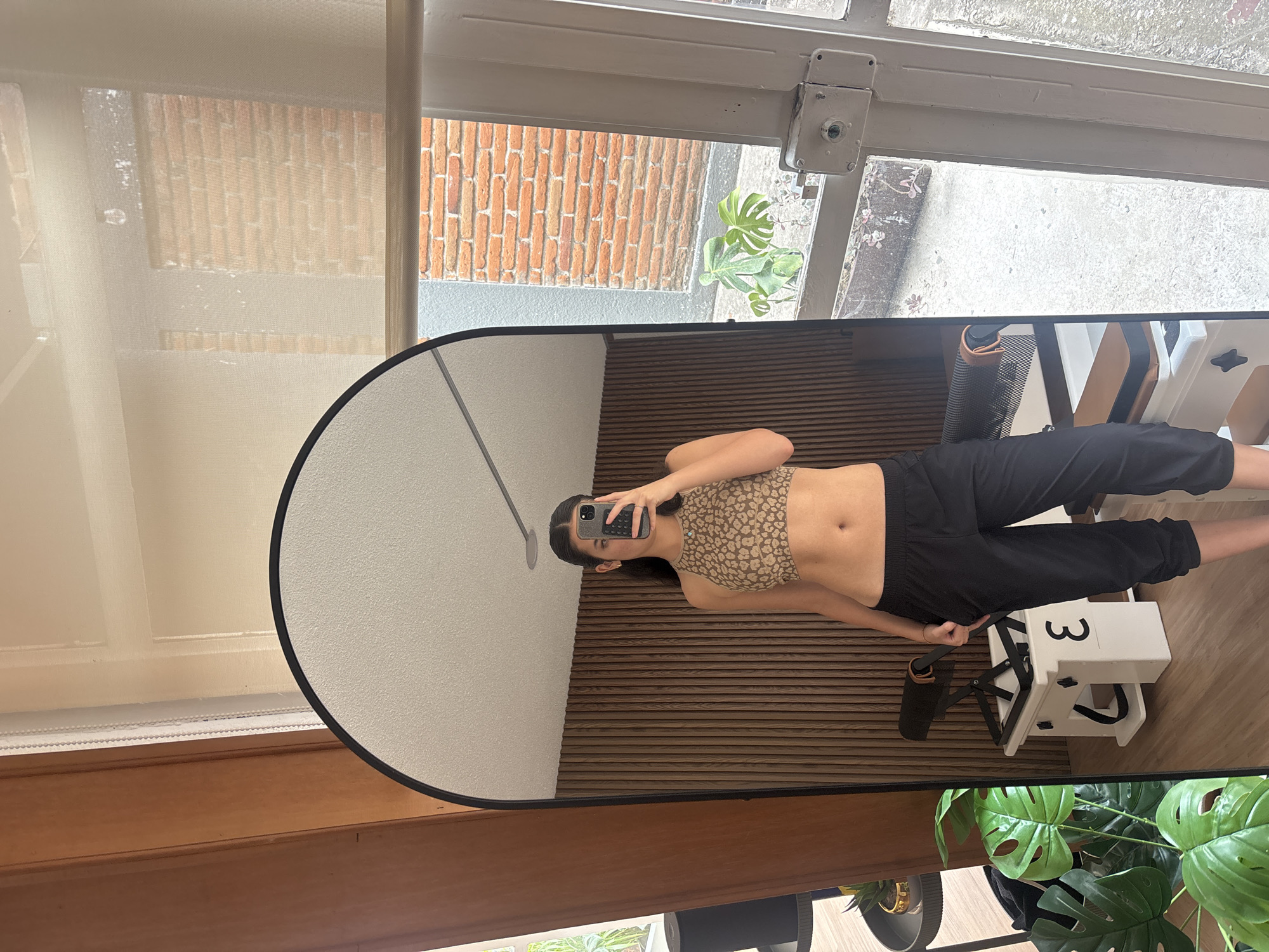 Woman takes mirror selfie in Puebla room