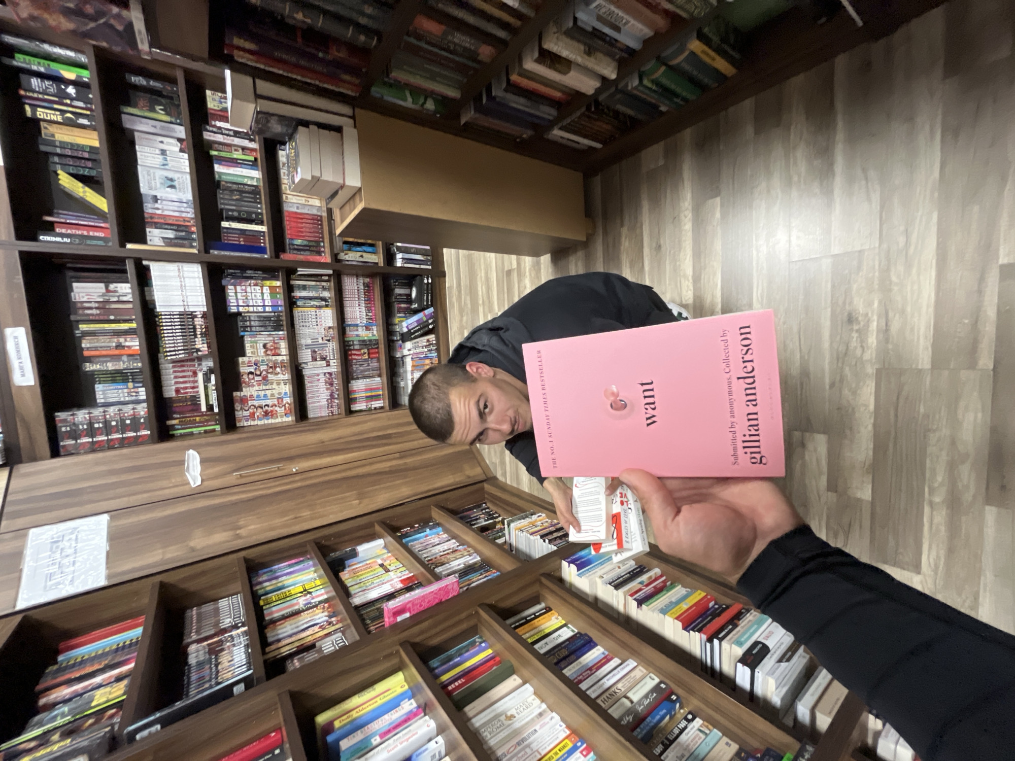 Man displays Gillian Anderson book in Bulgarian bookstore