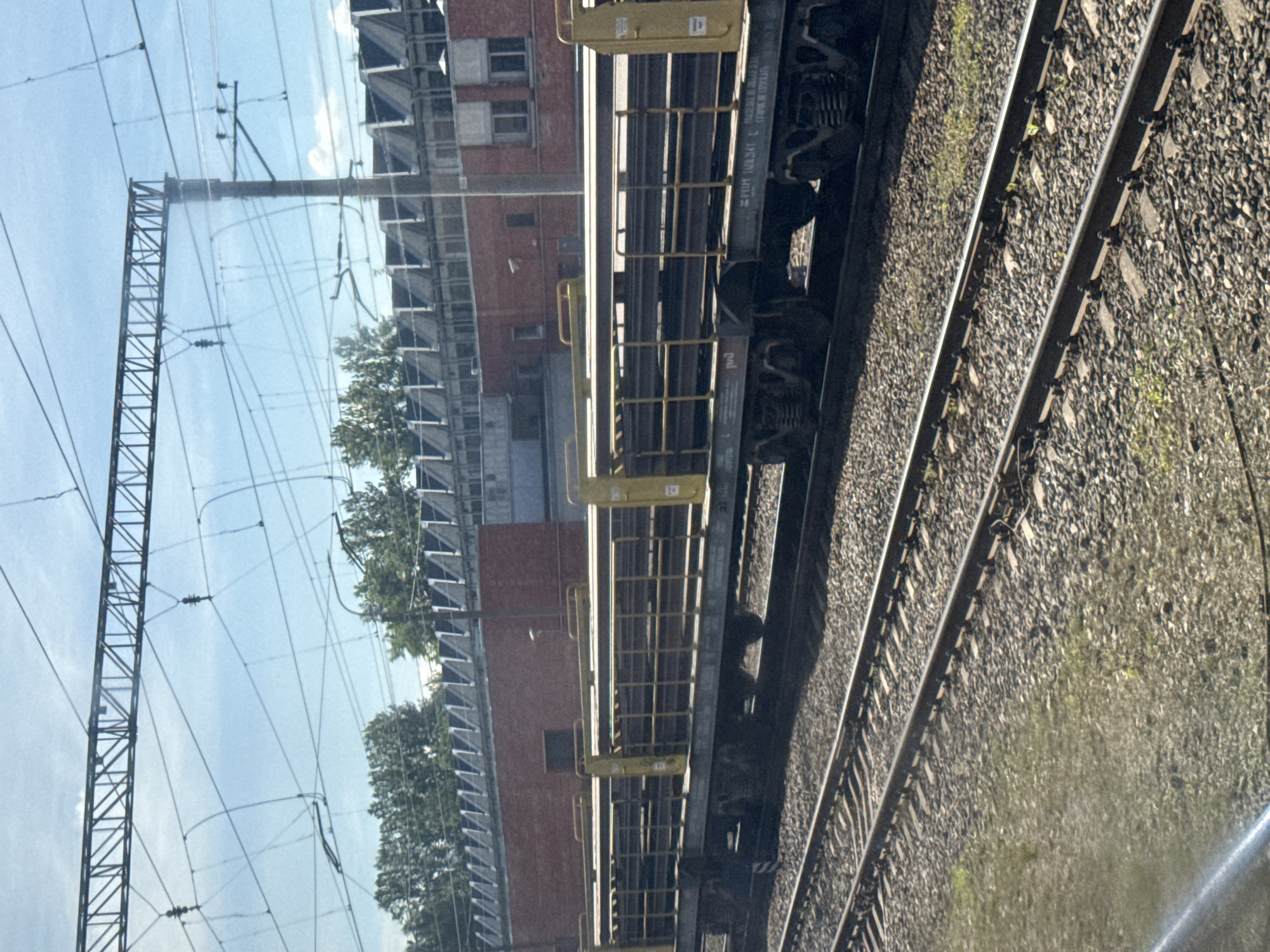 Freight train hauling metal beams through Saint Petersburg rail corridor