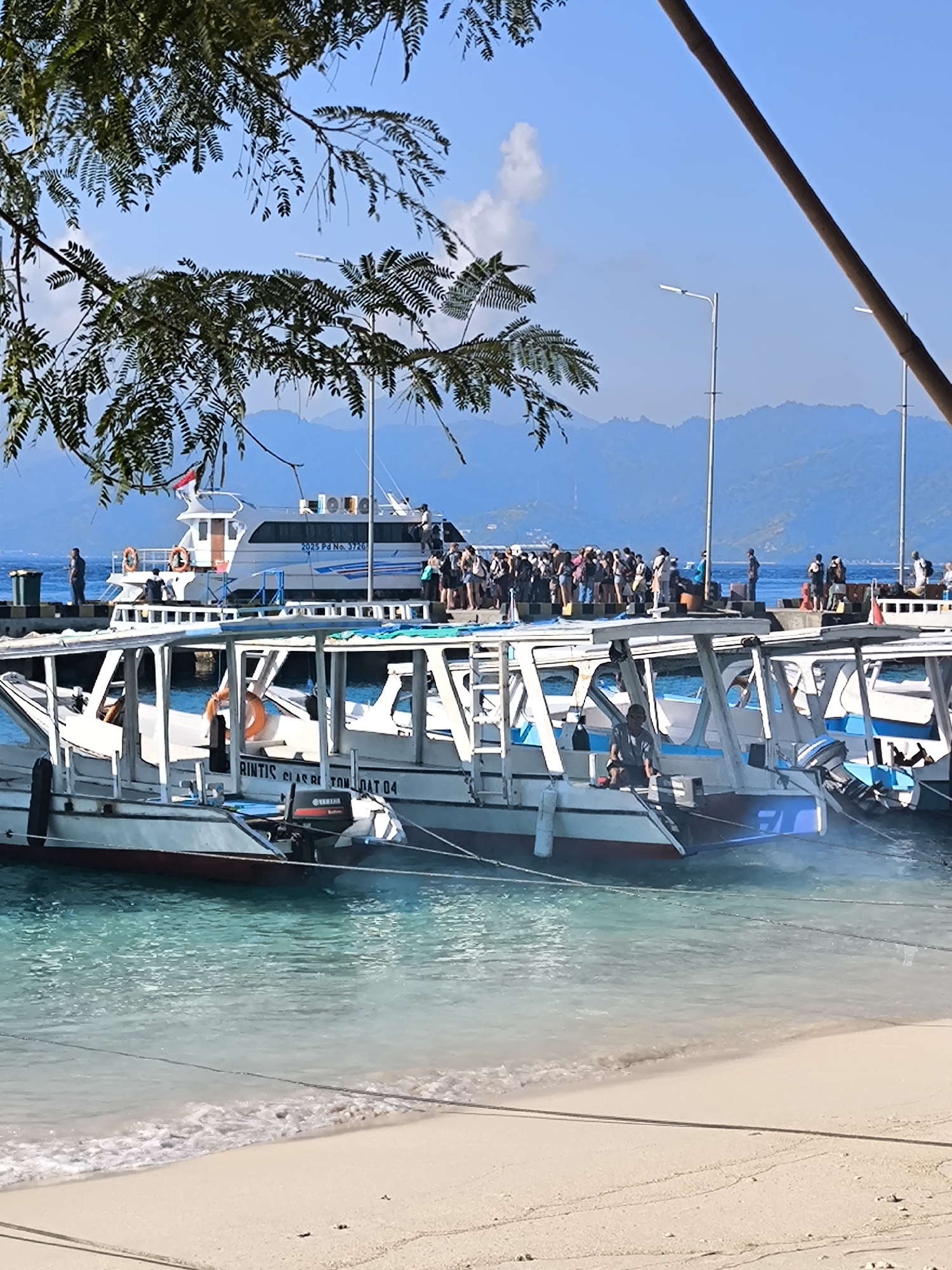 Boats moored at a quiet tropical harbor in Indonesia