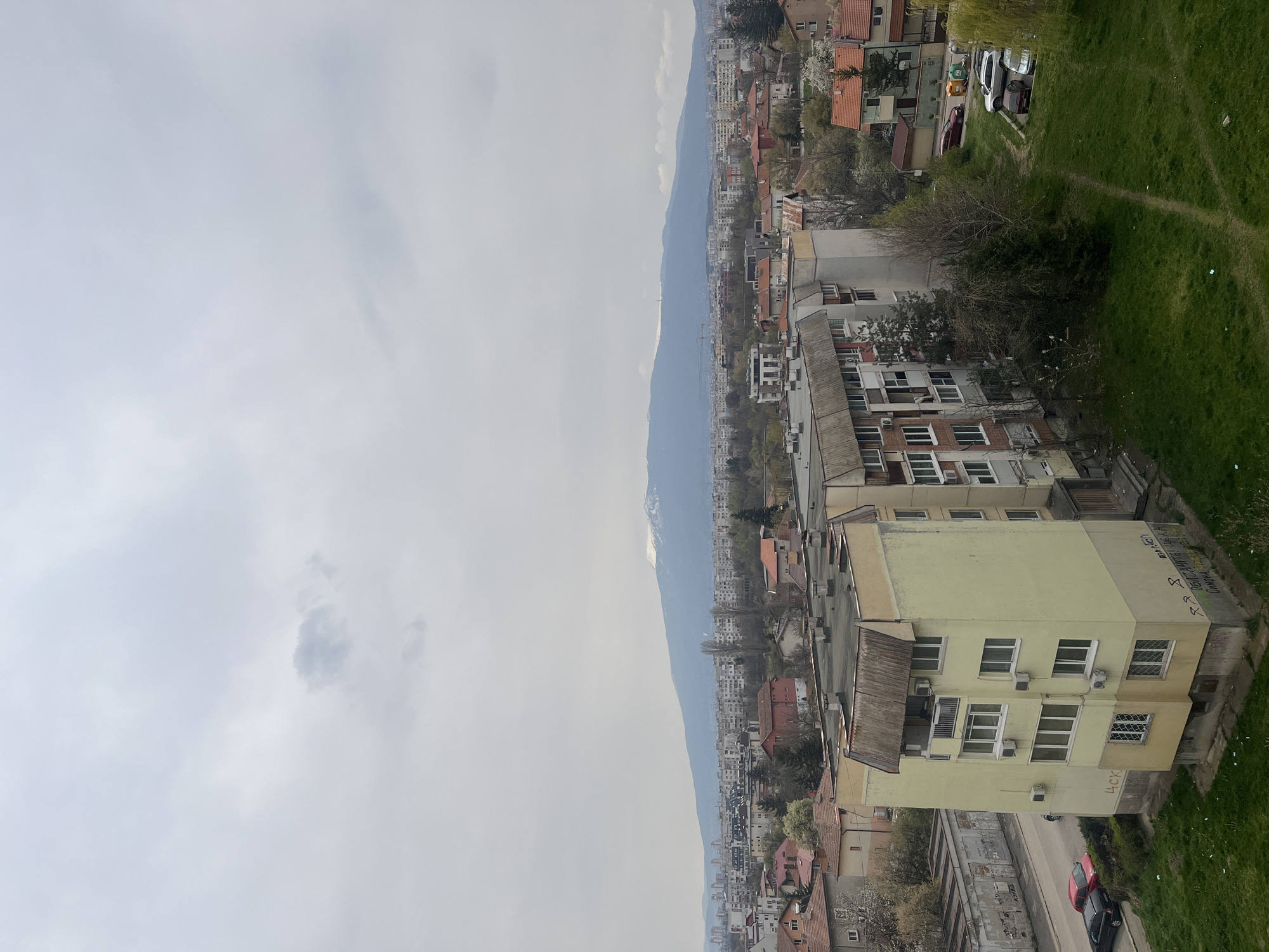 Overcast morning captured across Sofia's residential districts, mountains visible