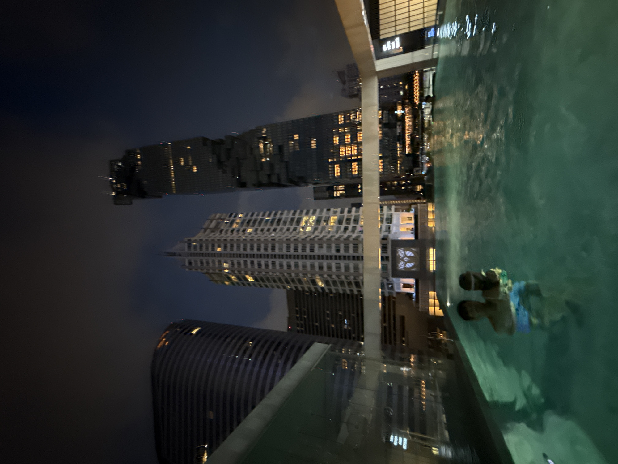 Rooftop pool night in Bangkok with skyline views