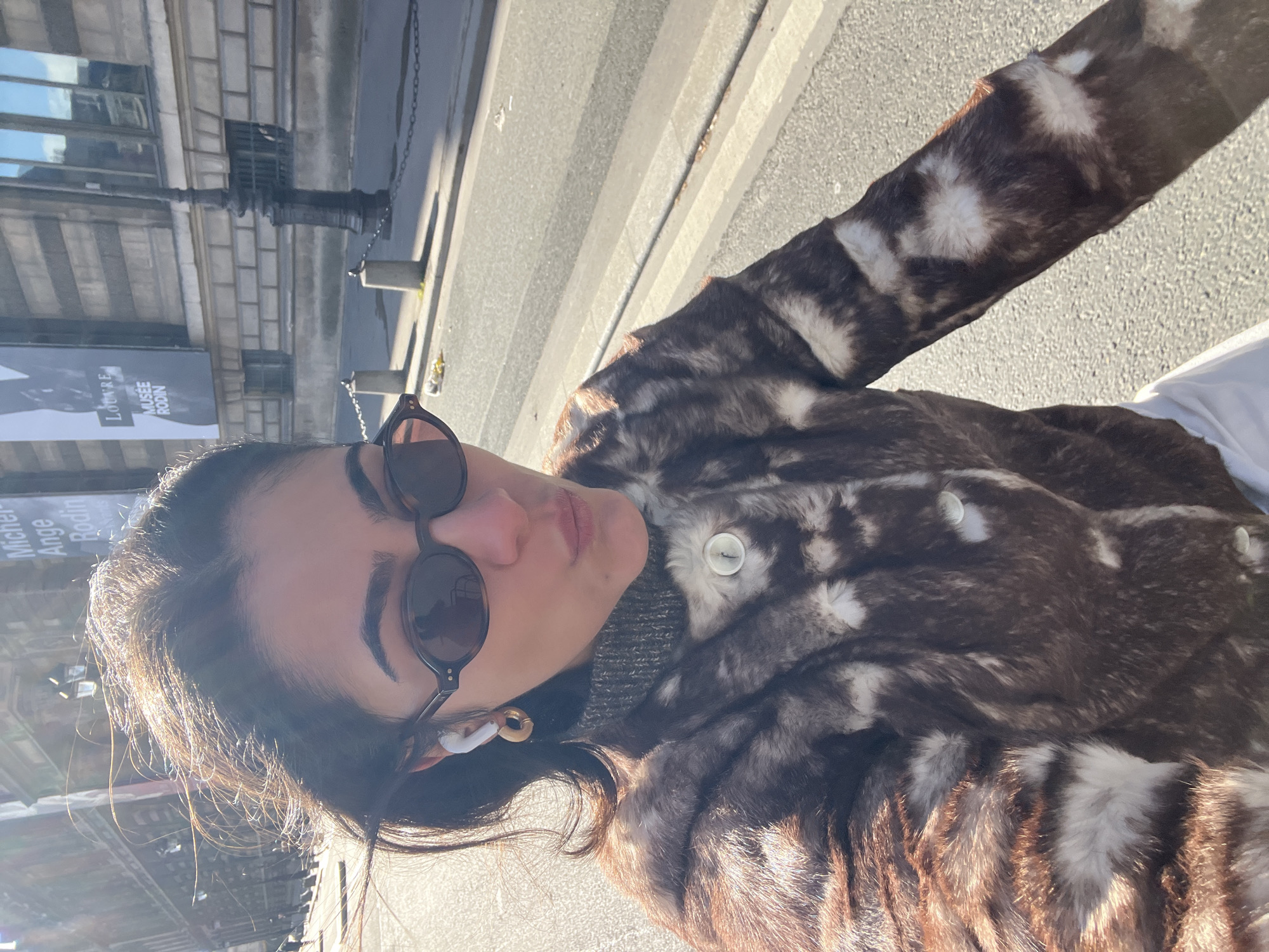 Woman takes selfies near Paris museums on sunny morning