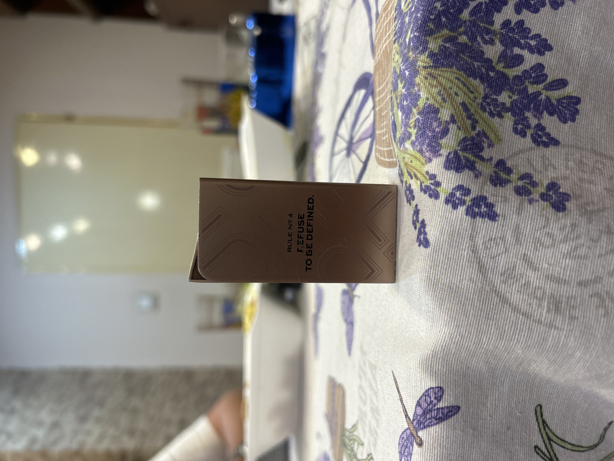 Energy drink, limes, and a card on a lavender tablecloth