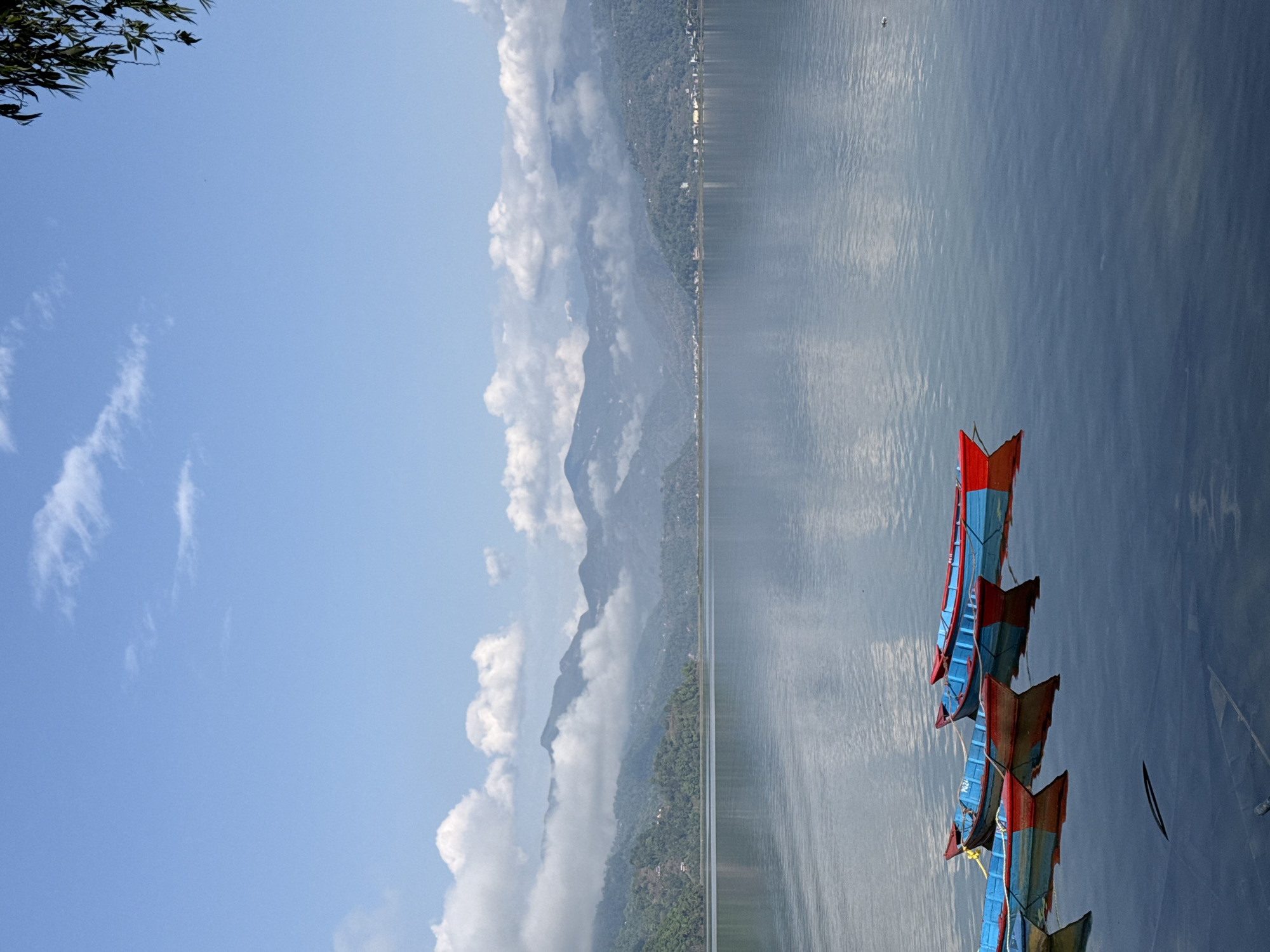 Colorful boats documented on Phewa Lake, Pokhara, Nepal
