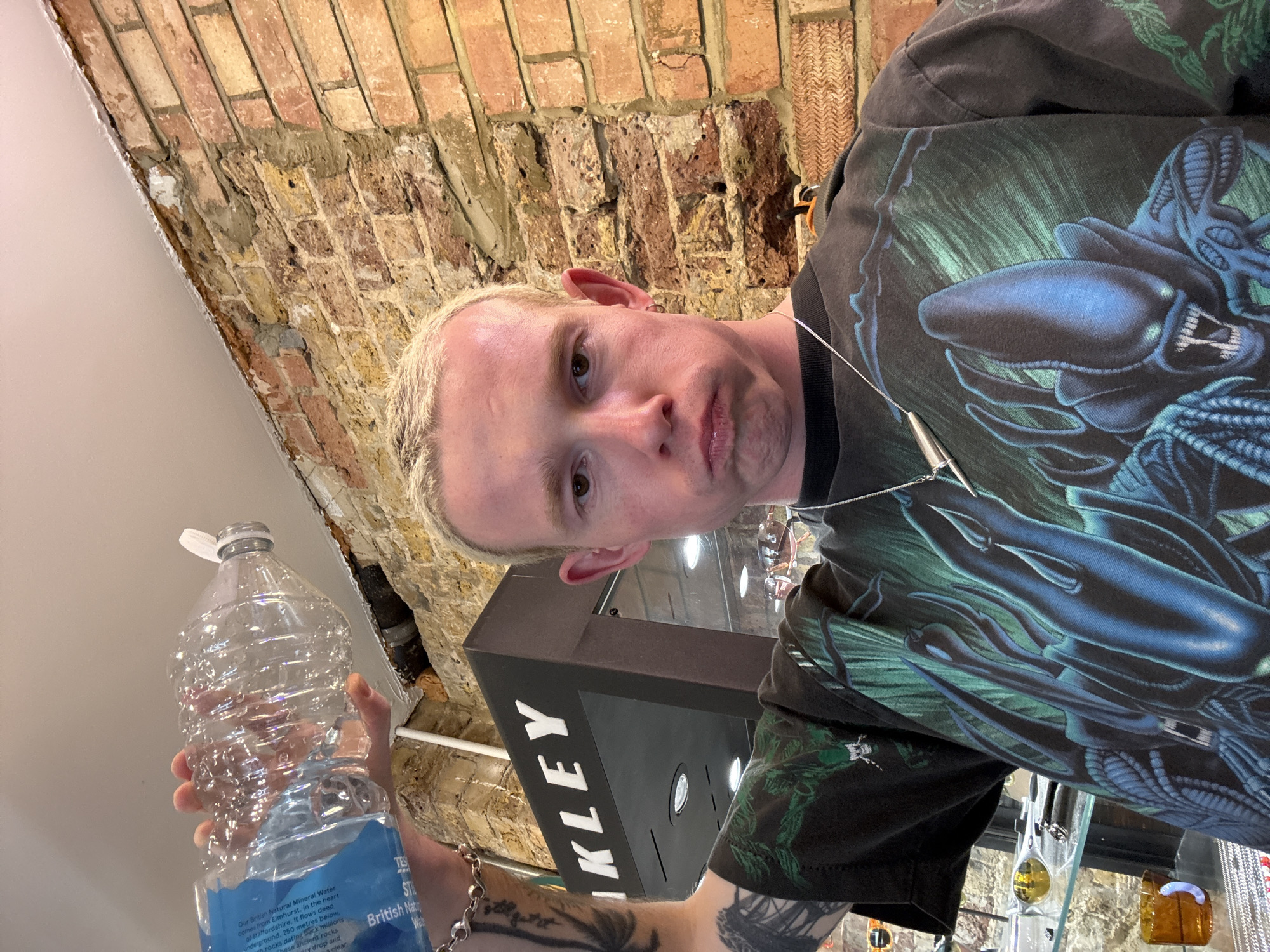 Man photographs himself with mineral water bottle in London