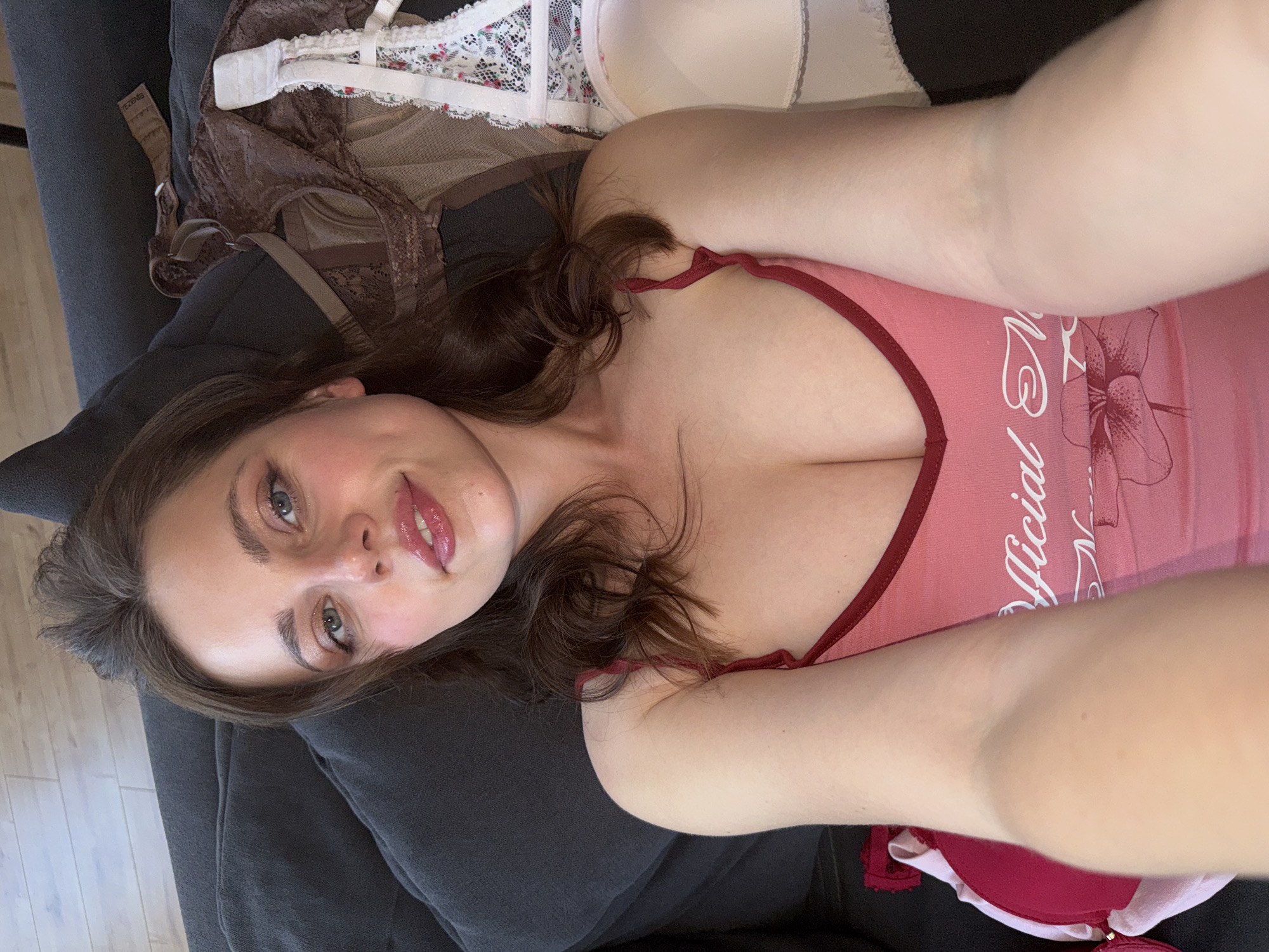 Woman takes multiple selfies on sofa in Budapest apartment