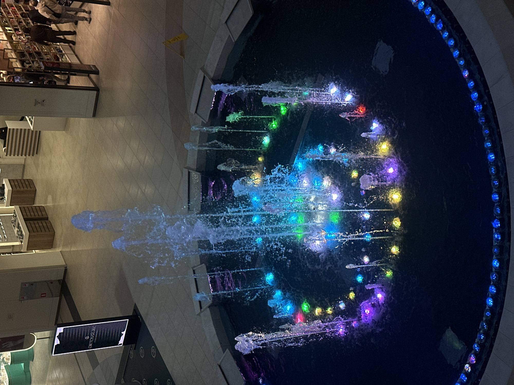 Illuminated fountain operates in Sochi shopping mall atrium