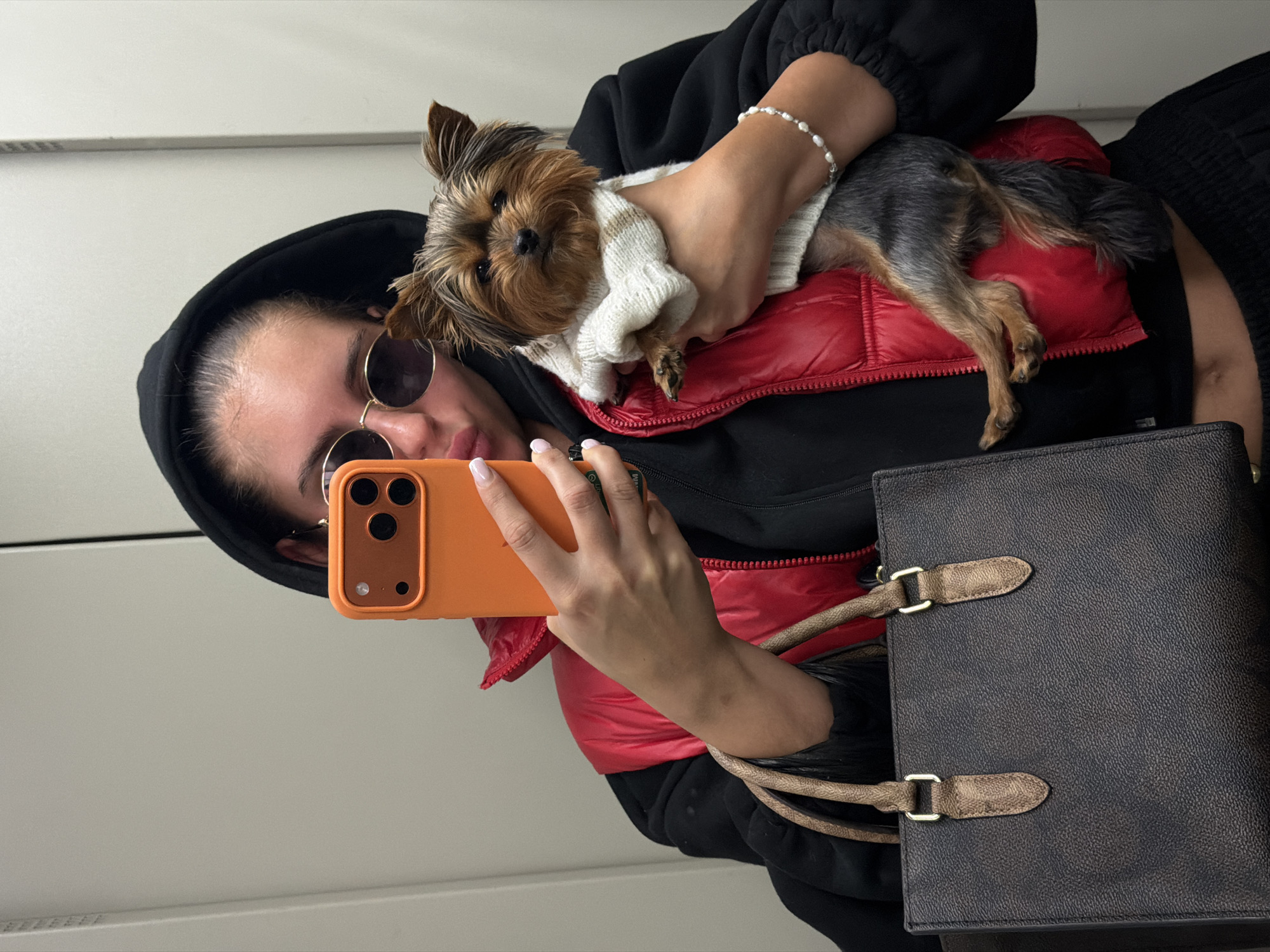 Woman takes selfie with puppy during cloudy morning in Divnogorsk