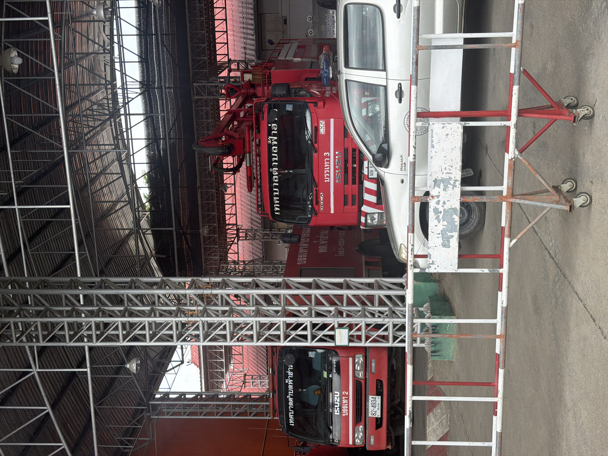 Fire station in Chang Phueak with trucks parked under metal roof