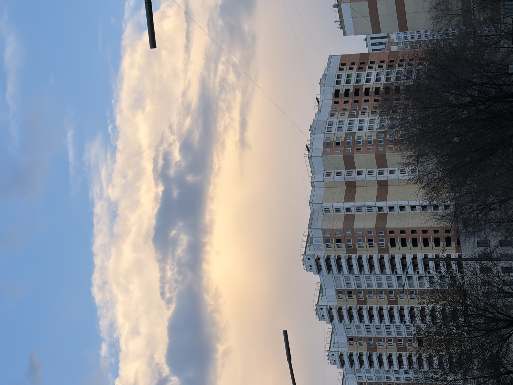 Moscow residential building observed under cloudy spring skies