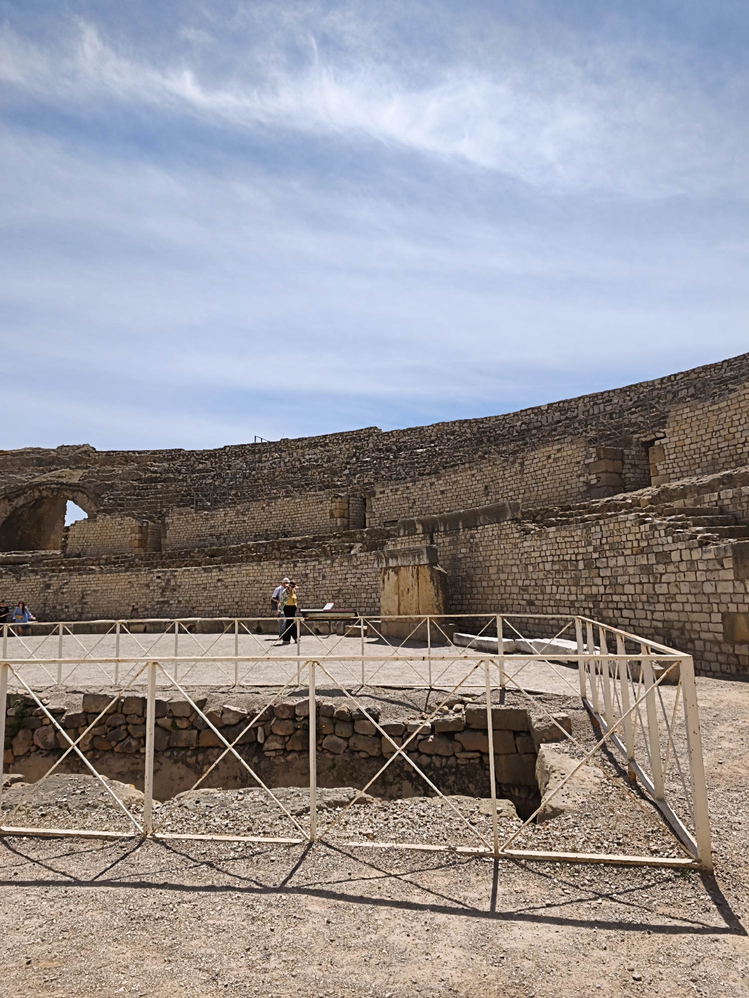 Visitor documents Roman Amphitheater ruins in sunny Tarragona