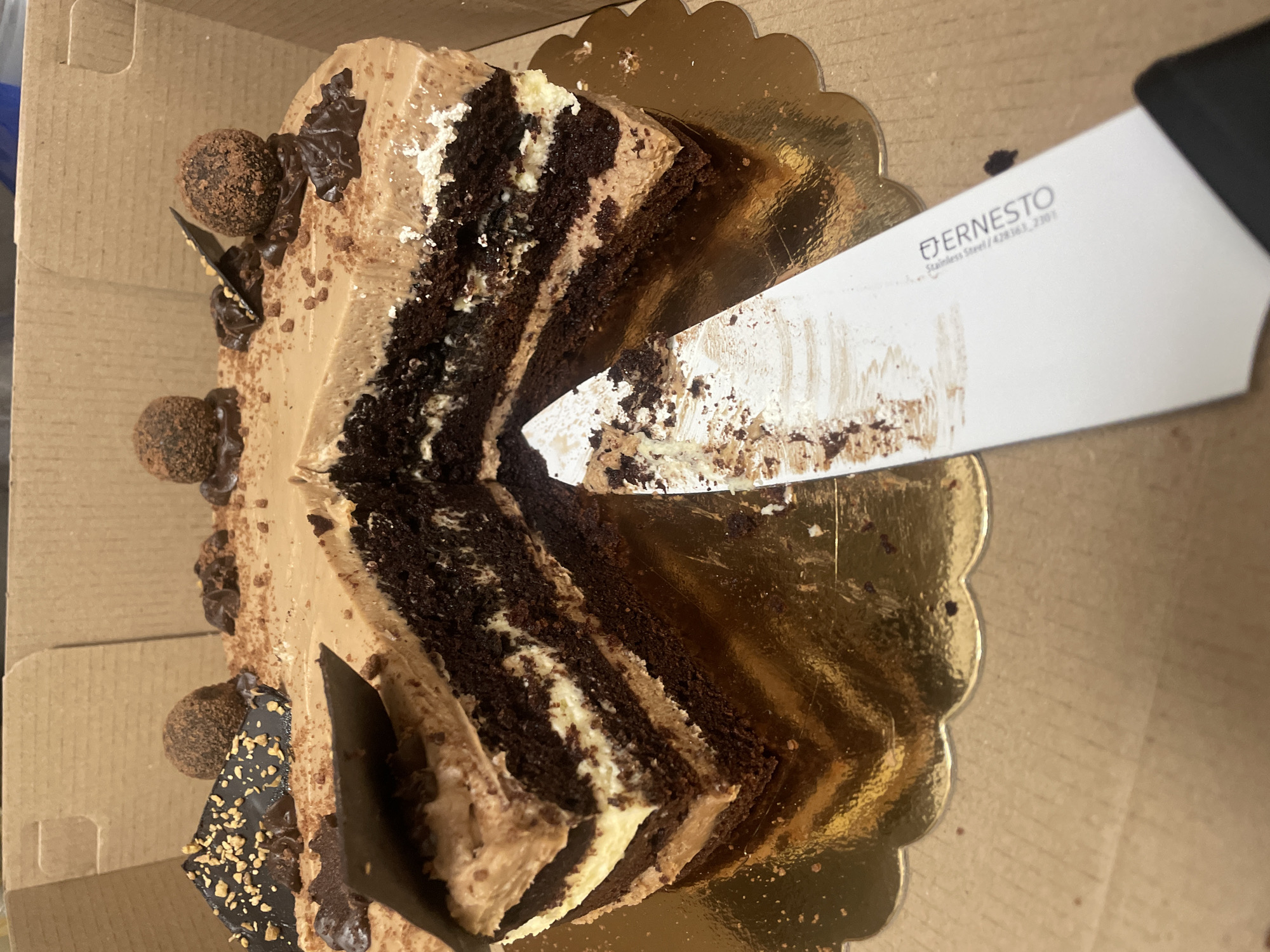 Chocolate layer cake being sliced in Sofia