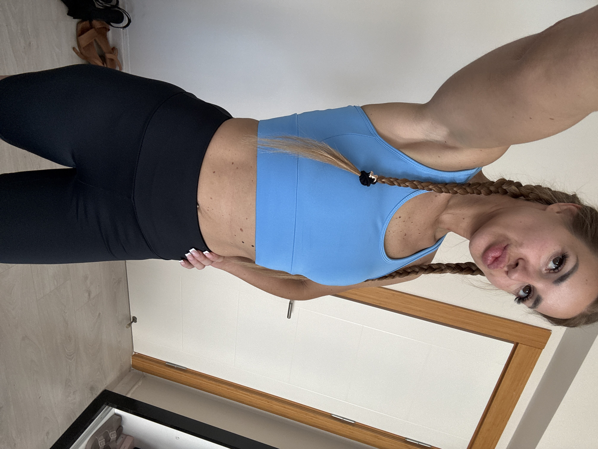 Woman takes indoor selfies in athletic wear in Erdemli