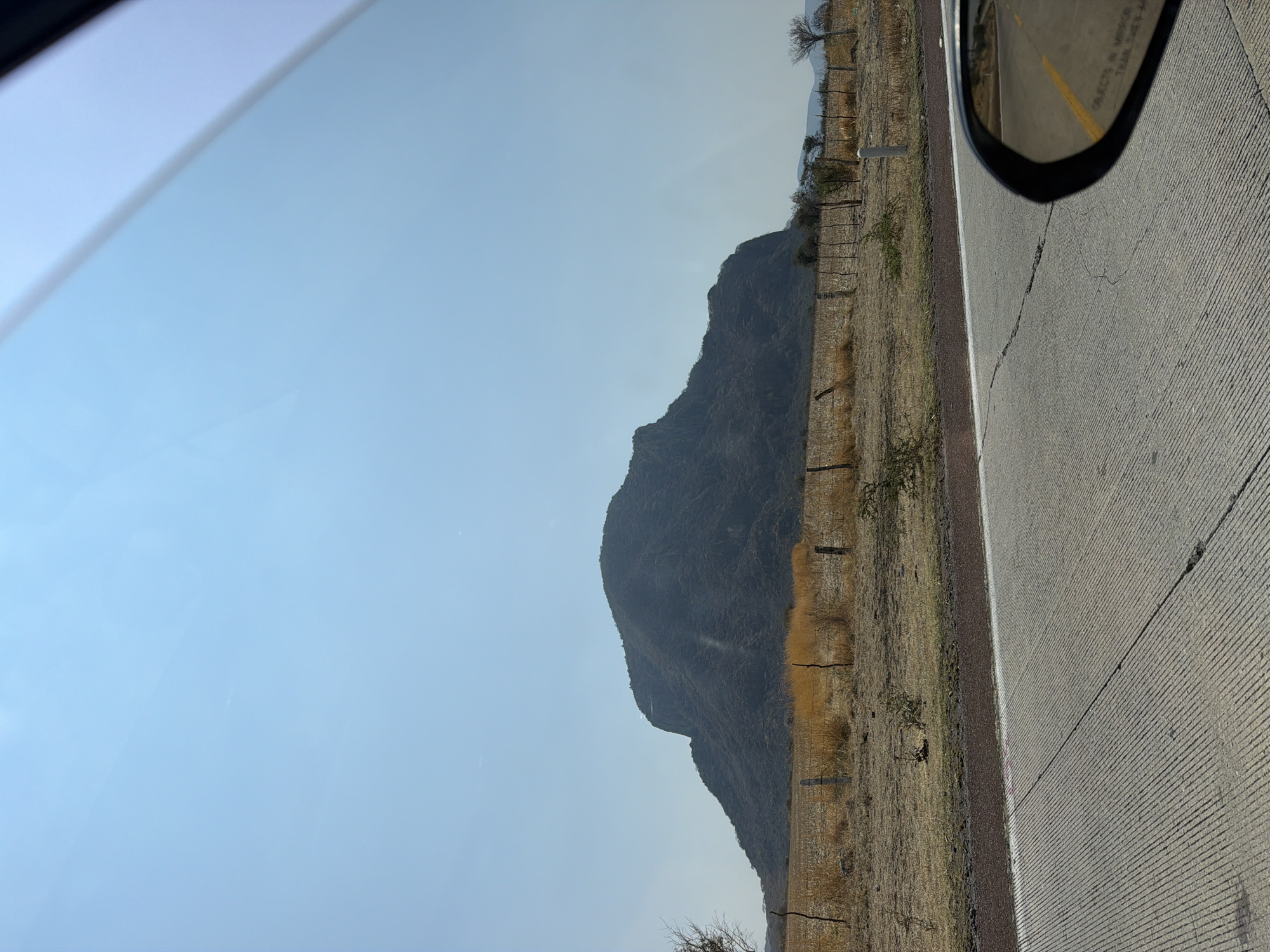 Traveler documents mountain landscape from vehicle in Jantetelco, Mexico