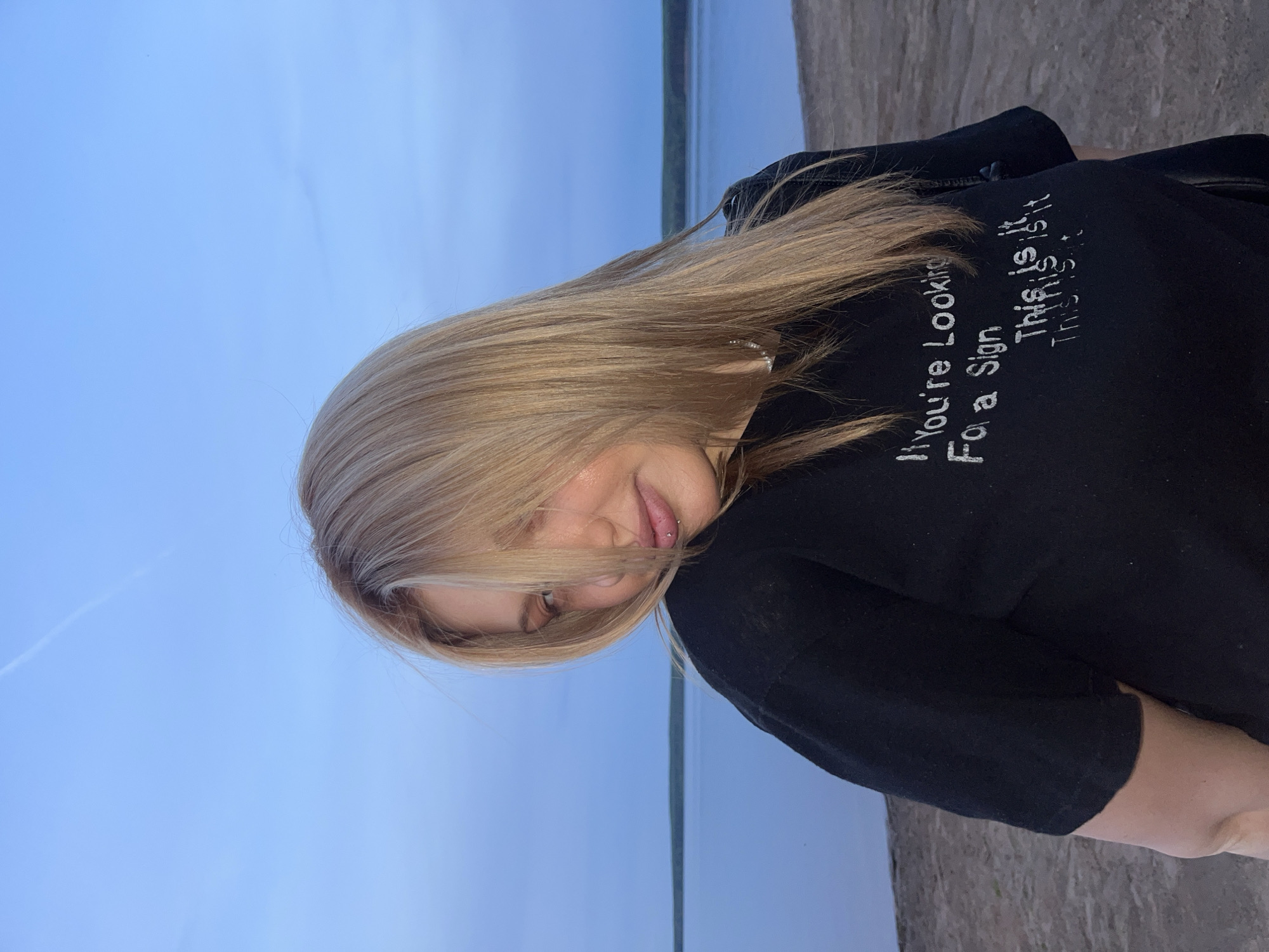 Woman poses for photos at Chaikovsky lakefront during evening