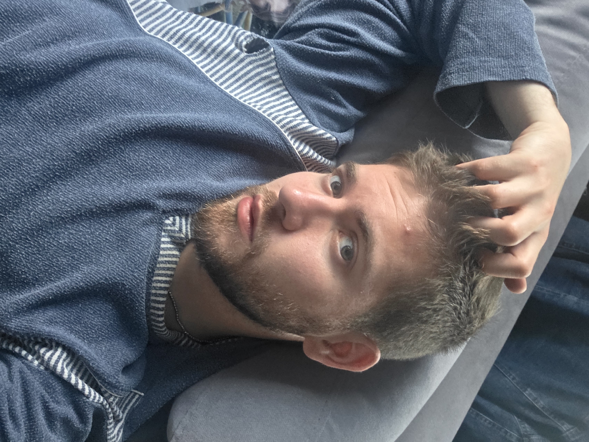 Man rests on couch, gives thumbs-up in Yagodovo