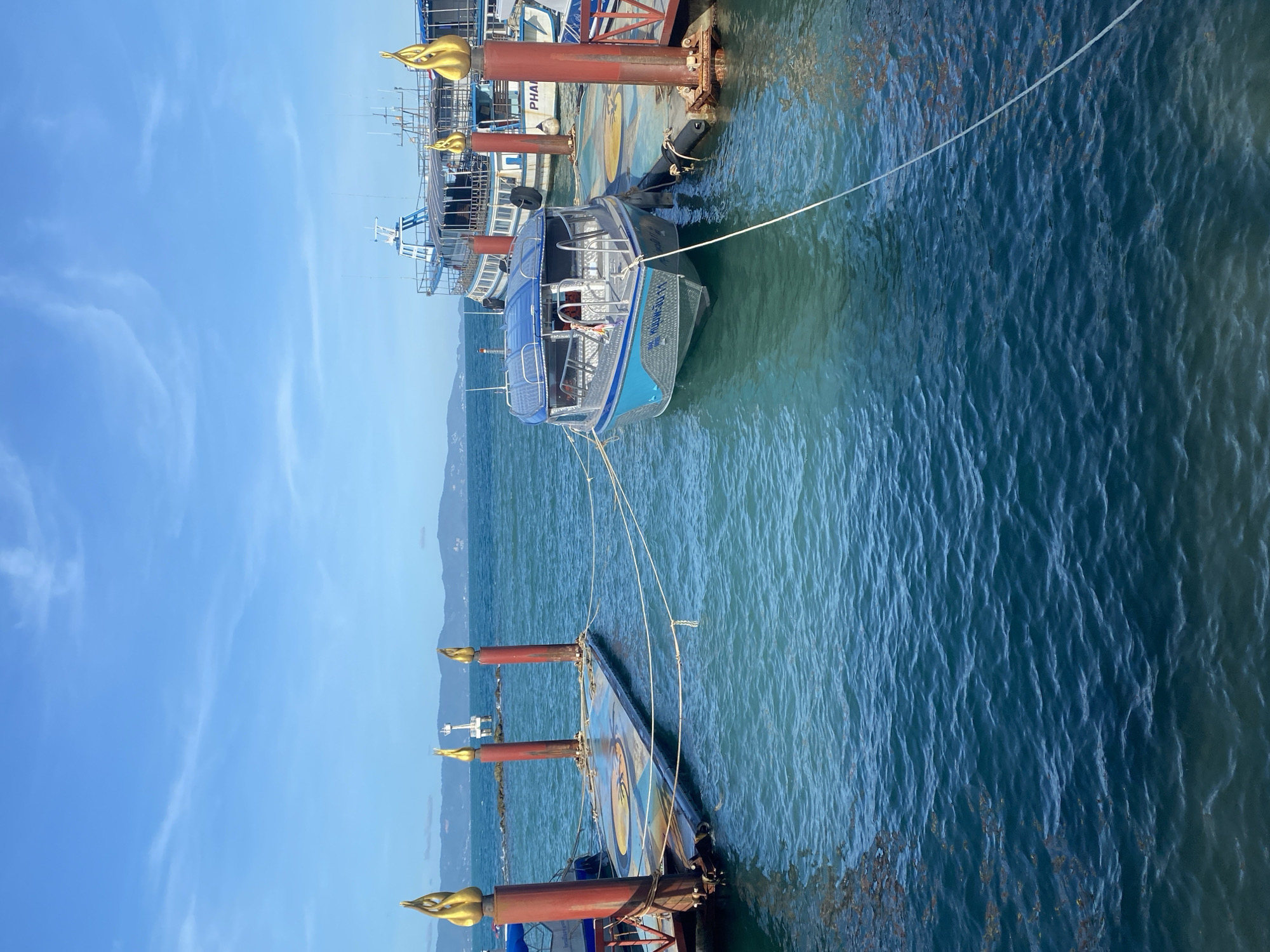 Palace pier documented with boats, Thai maritime insignia visible