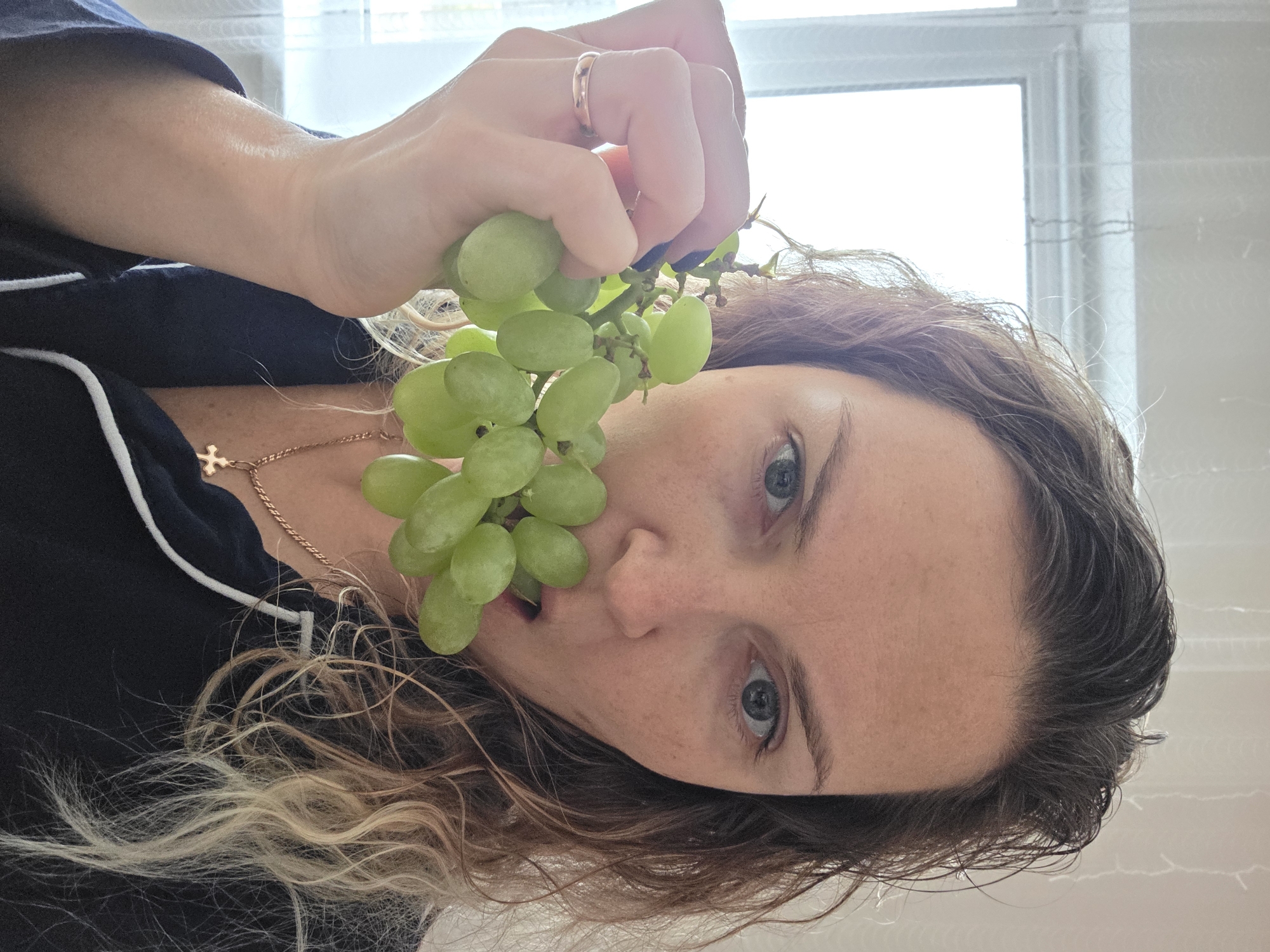 Woman poses with grapes in early morning, Chaikovsky