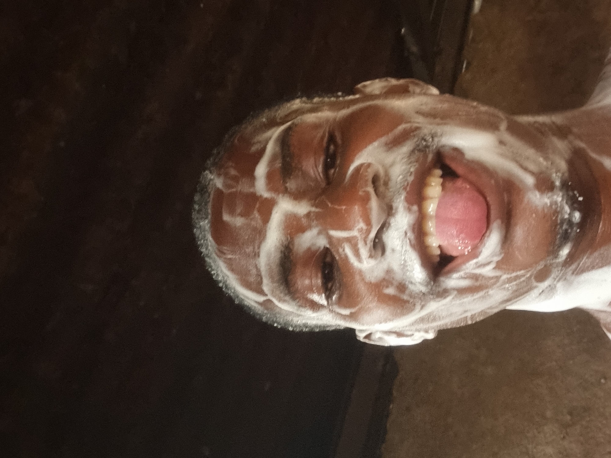 Man's face covered in soap foam captured in Onitsha