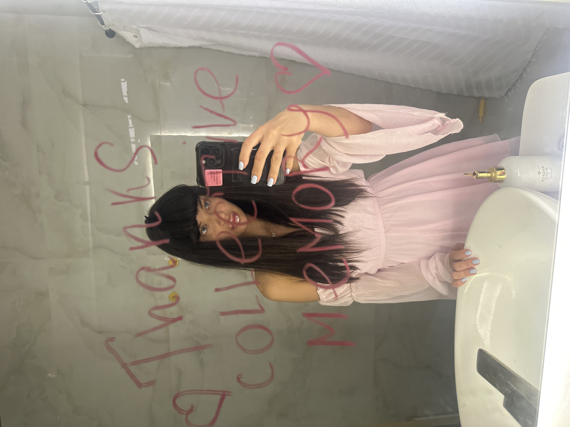 Woman takes bathroom mirror selfie in Khimki, Russia