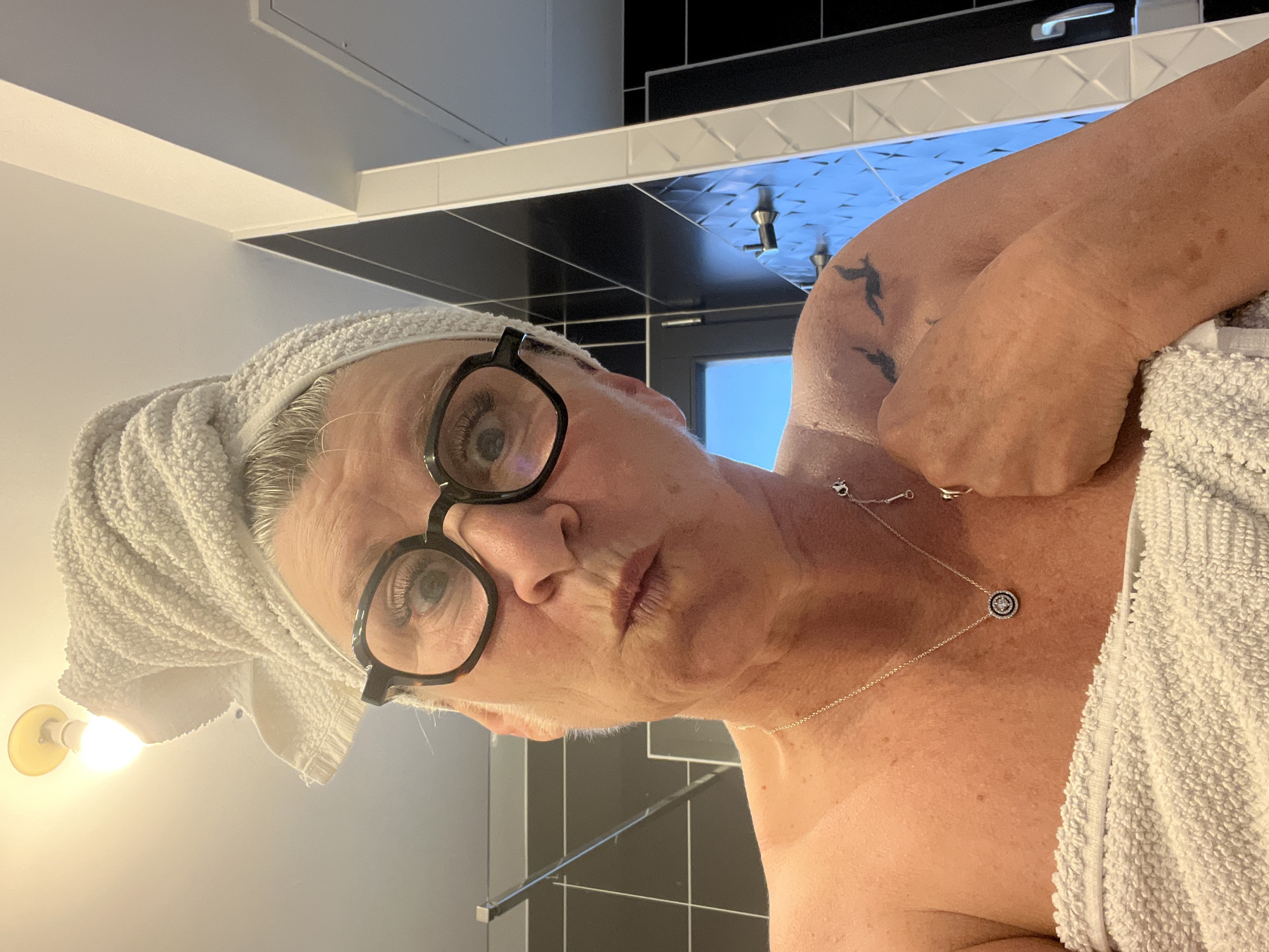 Woman observed in bathroom wearing towel in Chambœuf, France