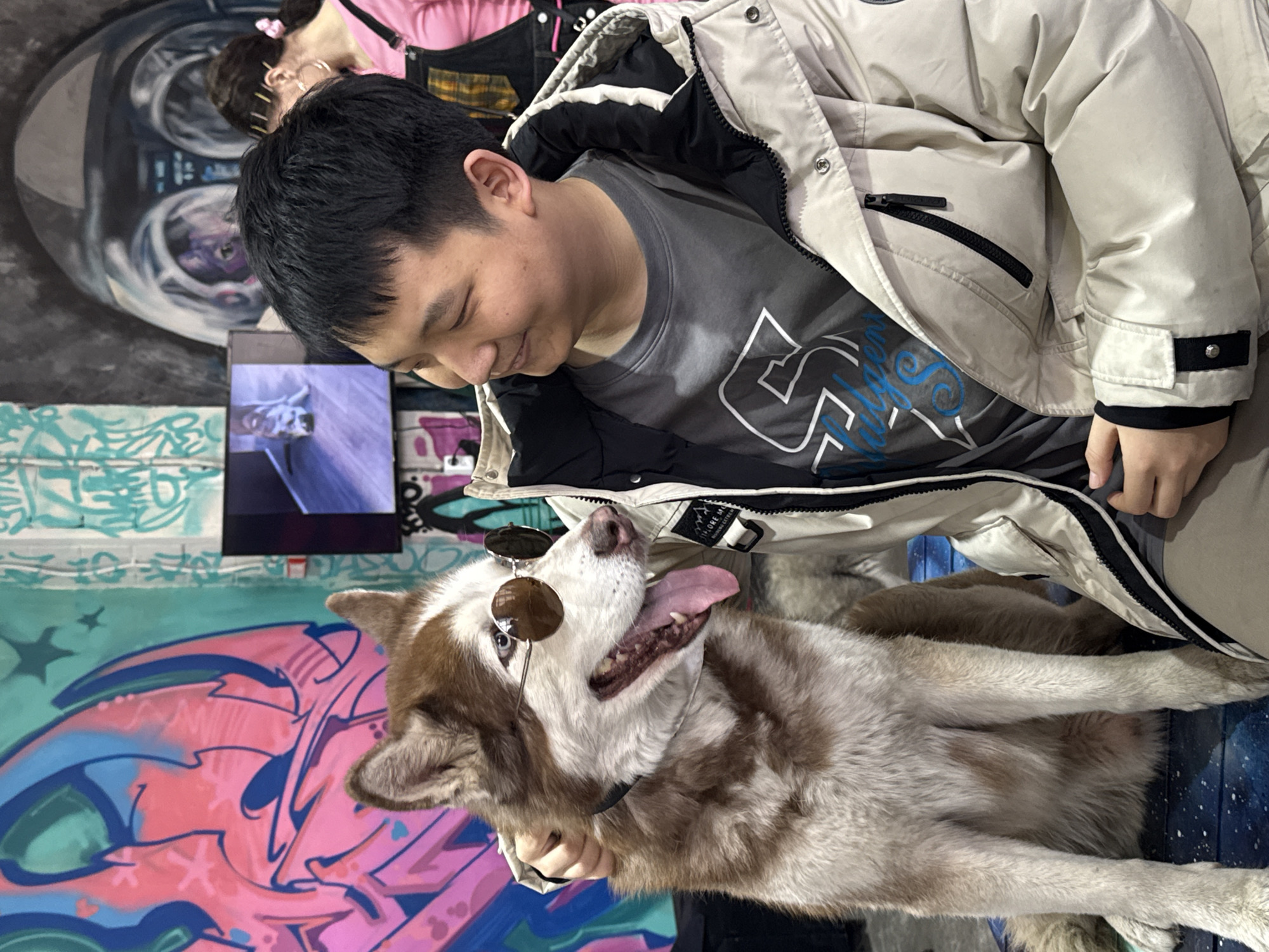 Visitors interact with husky dogs at Saint Petersburg art gallery