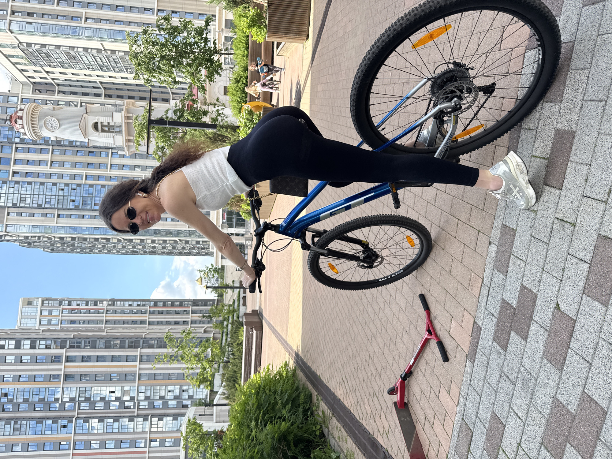 Woman enjoys sunny morning bike ride in Moscow park